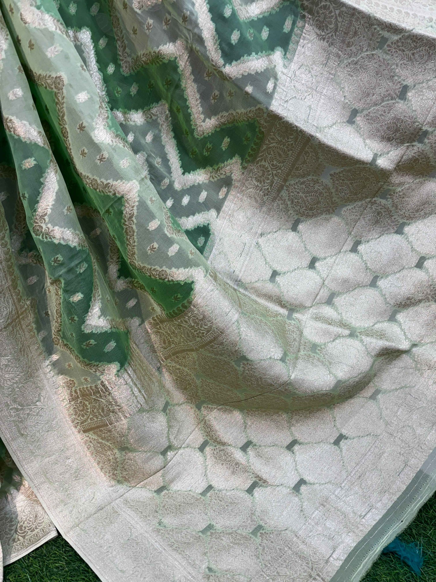 White pallu with sea-green Banarasi motifs and wide patterned border, gold accents