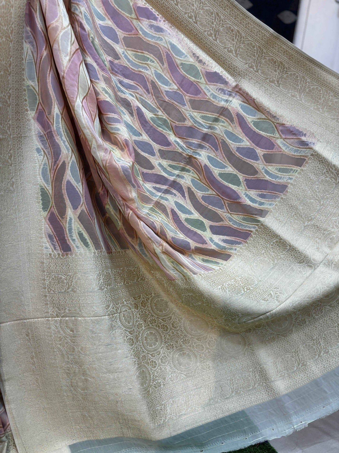 Cream saree pallu with pastel pink, teal, and gold wave pattern and zari edge