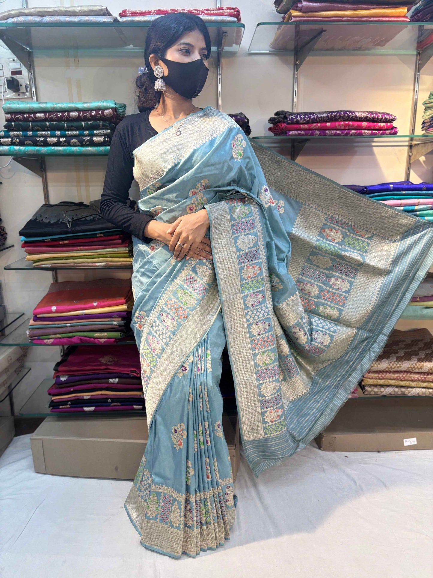 Sky-blue handloom saree draped with wide woven border and patterned pallu