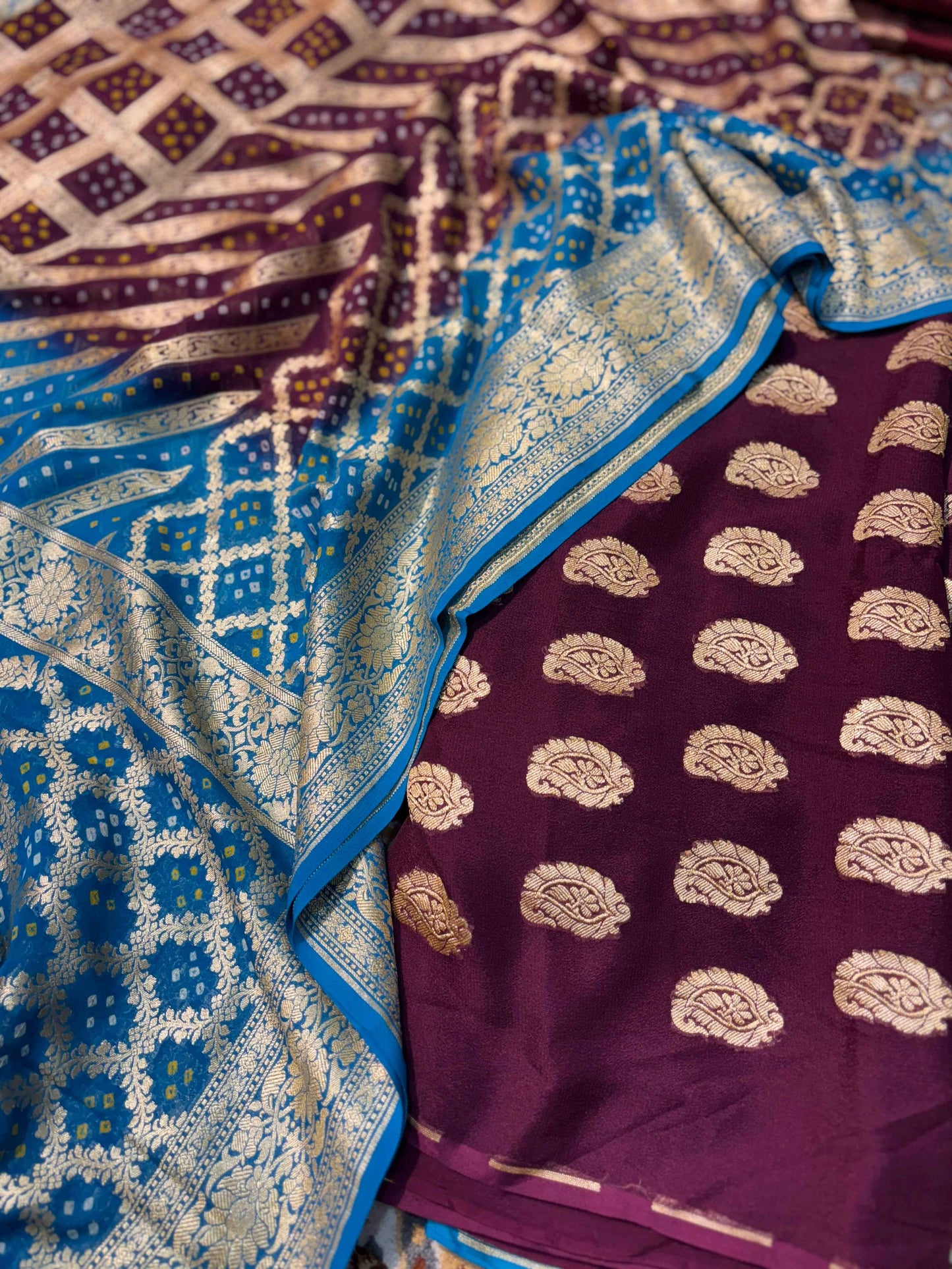 Blue bandhej georgette fabric with ornate border on maroon panel with gold motifs