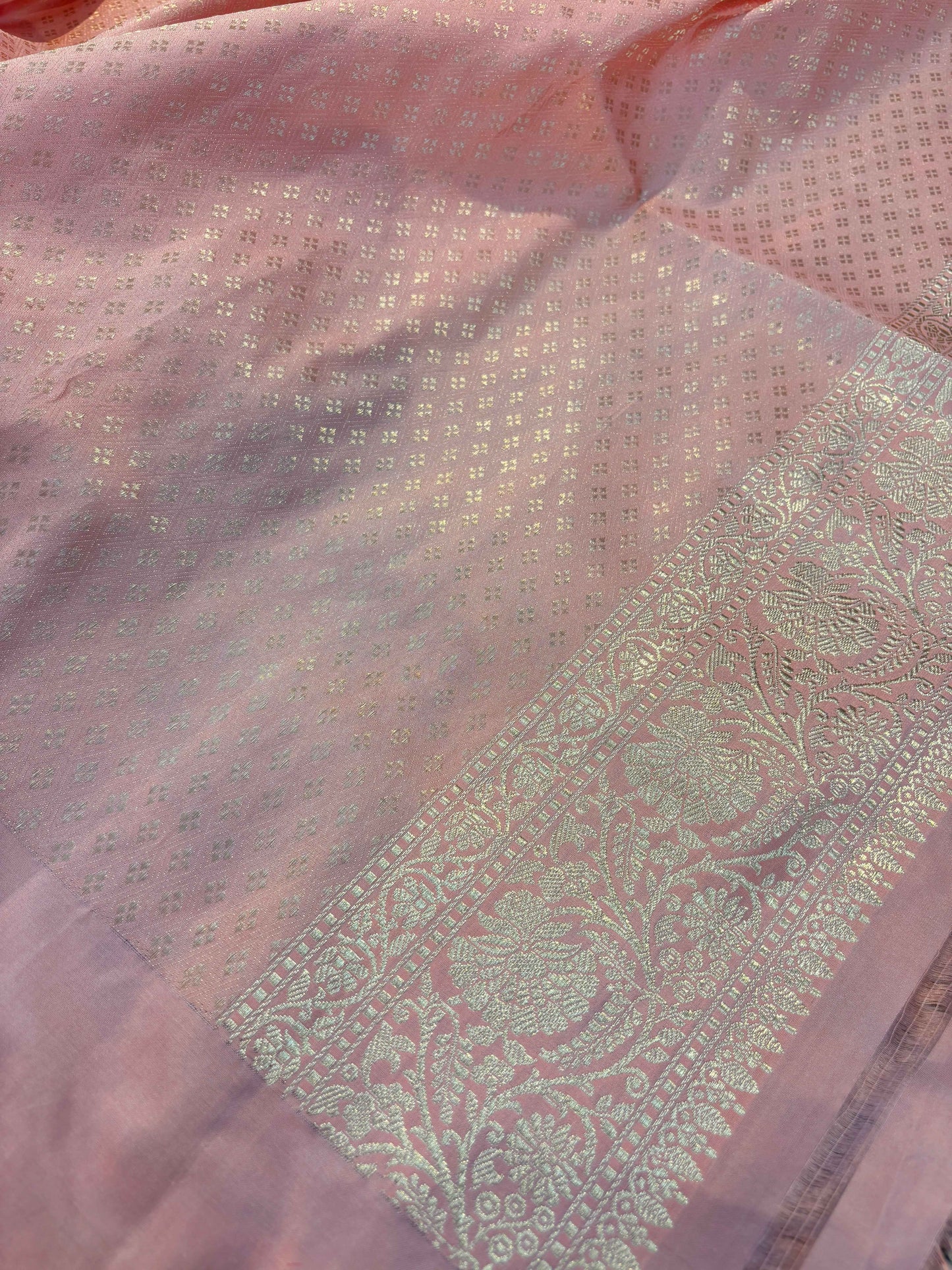 Pink Banarasi saree body with zari-style border and woven leaf motifs