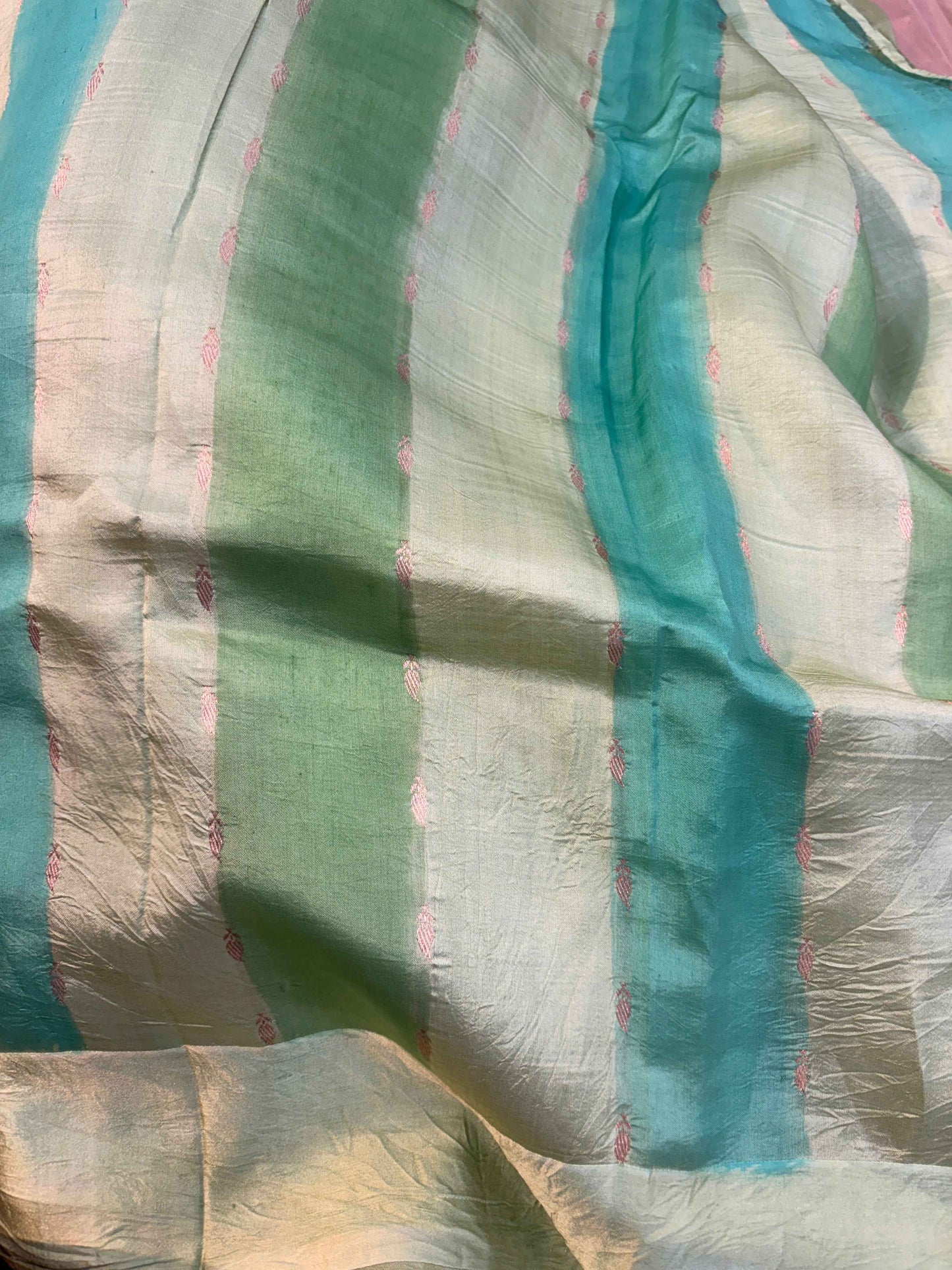 Light green and teal saree fabric with woven stripes and scattered motifs