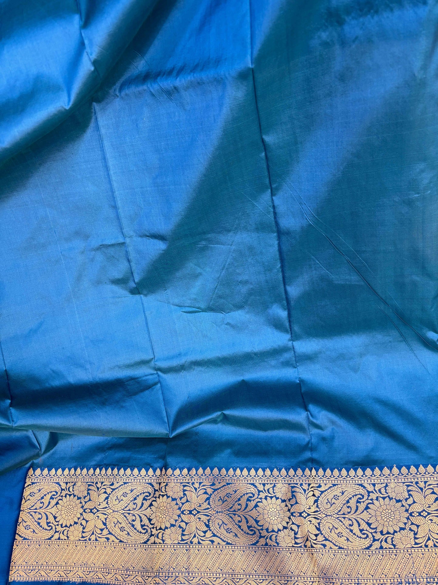 Blue saree fabric with silver-gold border panel