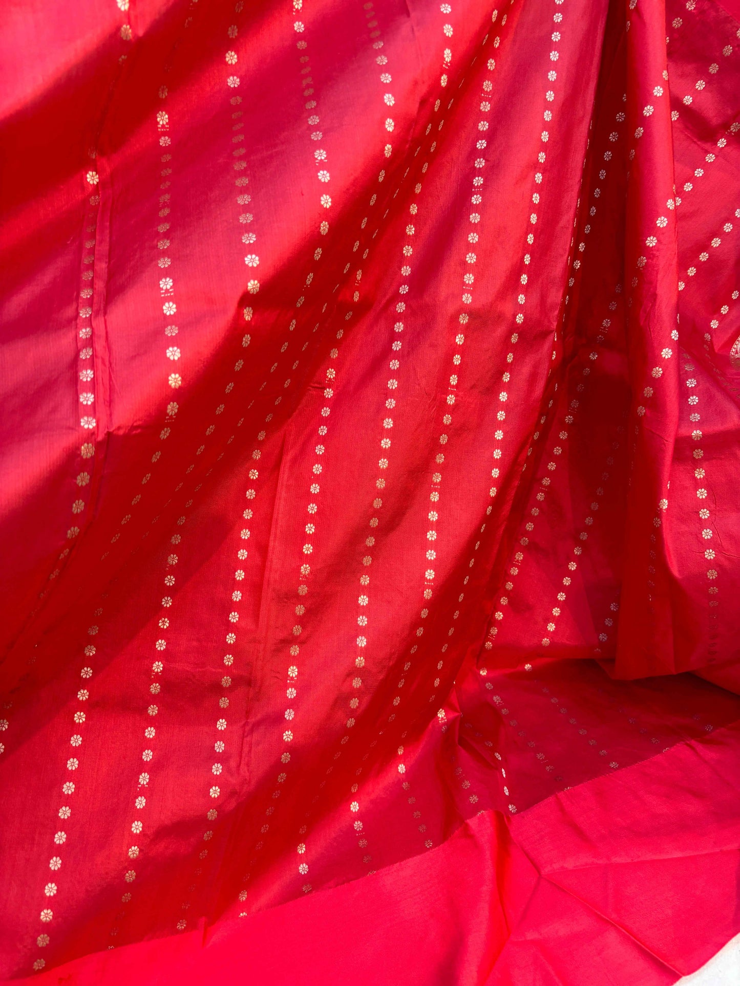 Red handloom saree section with tiny dot motifs and ornate weave