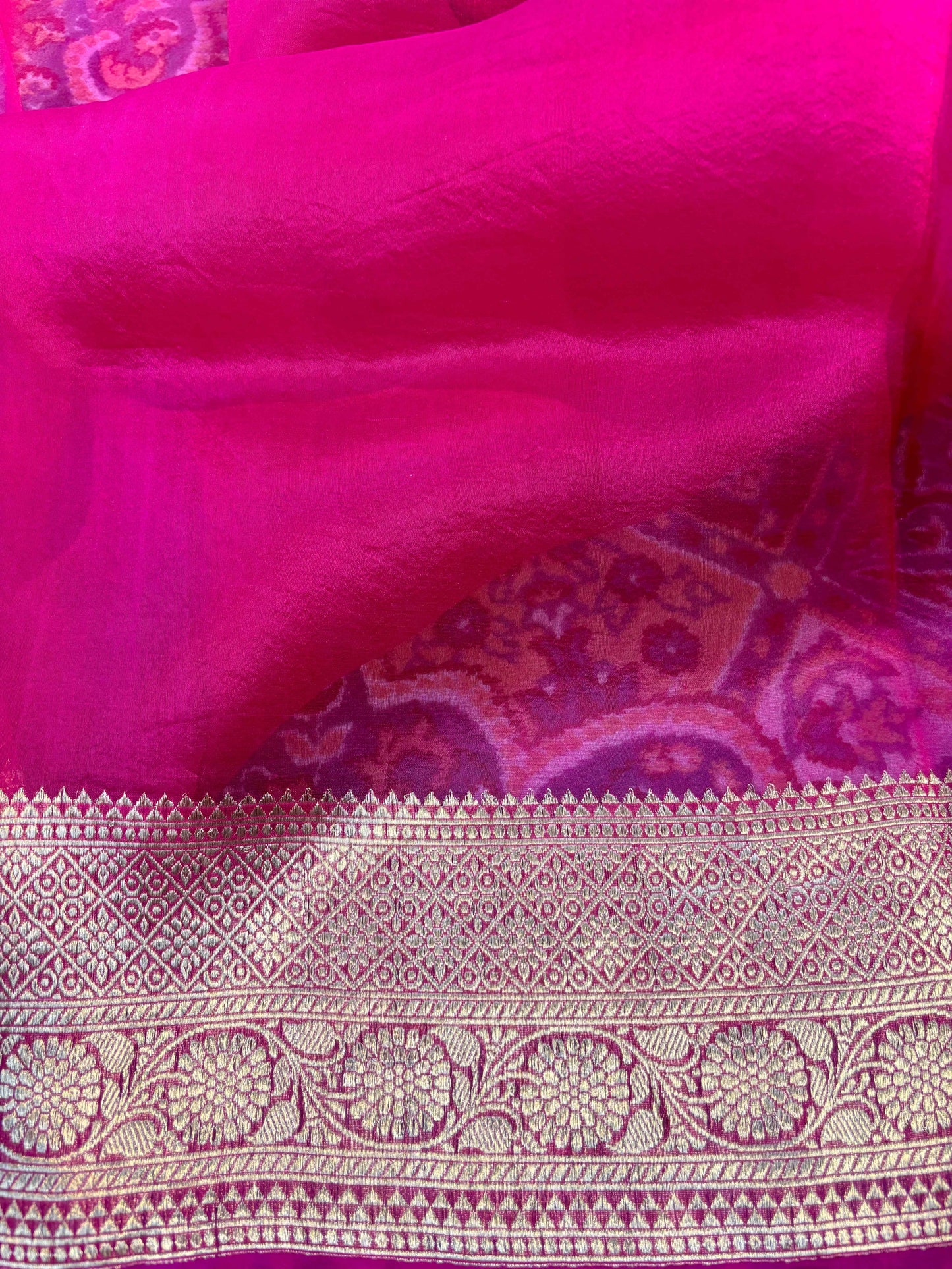 Magenta silk saree with gold border and ornate patterned band