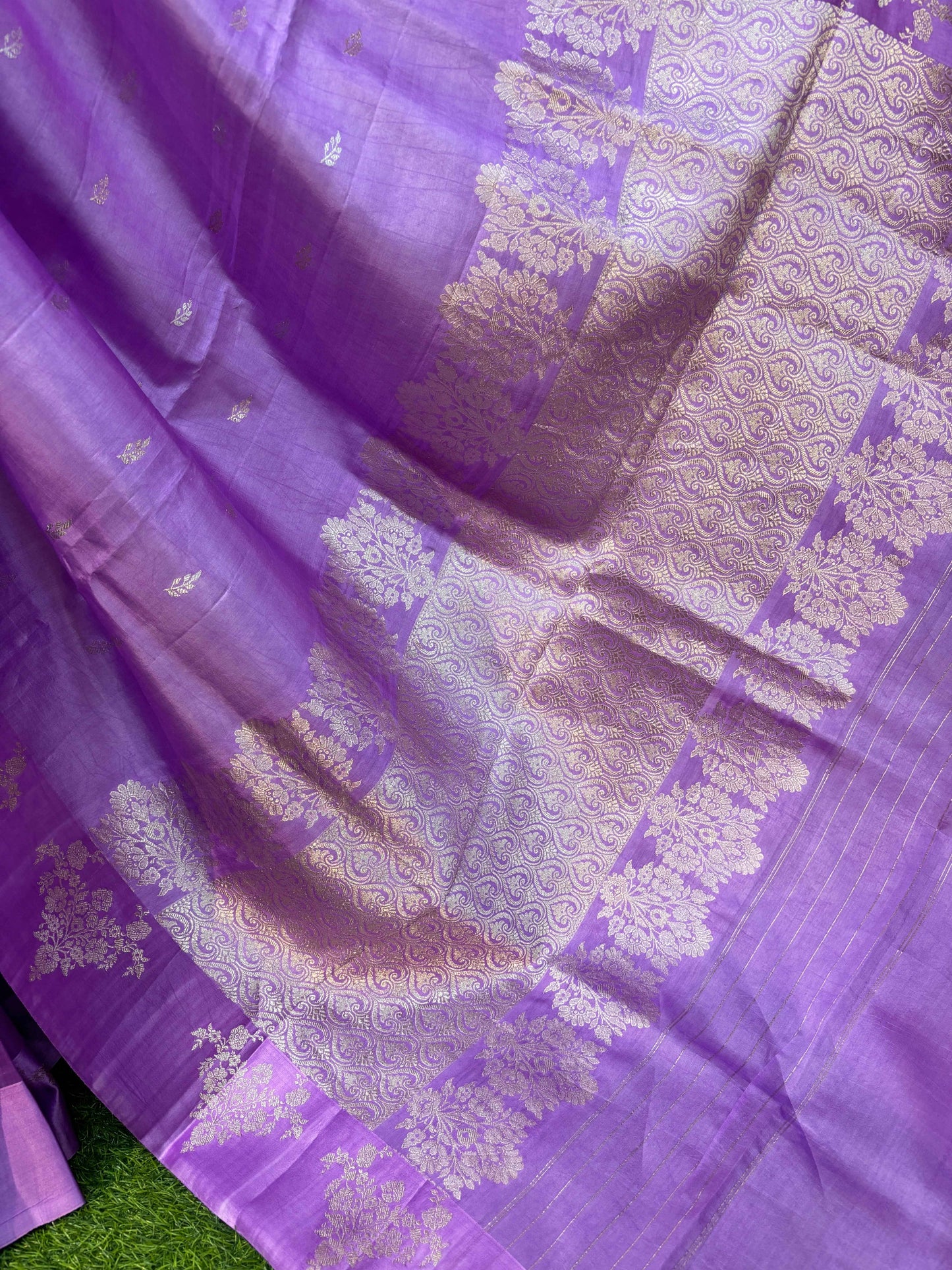 Lavender silk saree with silver-gold zari texture and ornate all-over motif