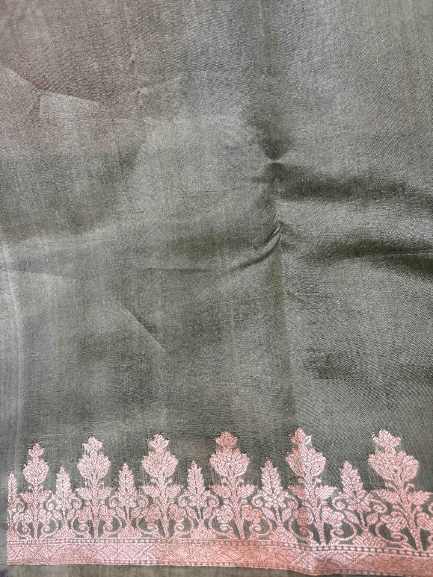 Pista green saree with ornate pink border panel and floral vine weave