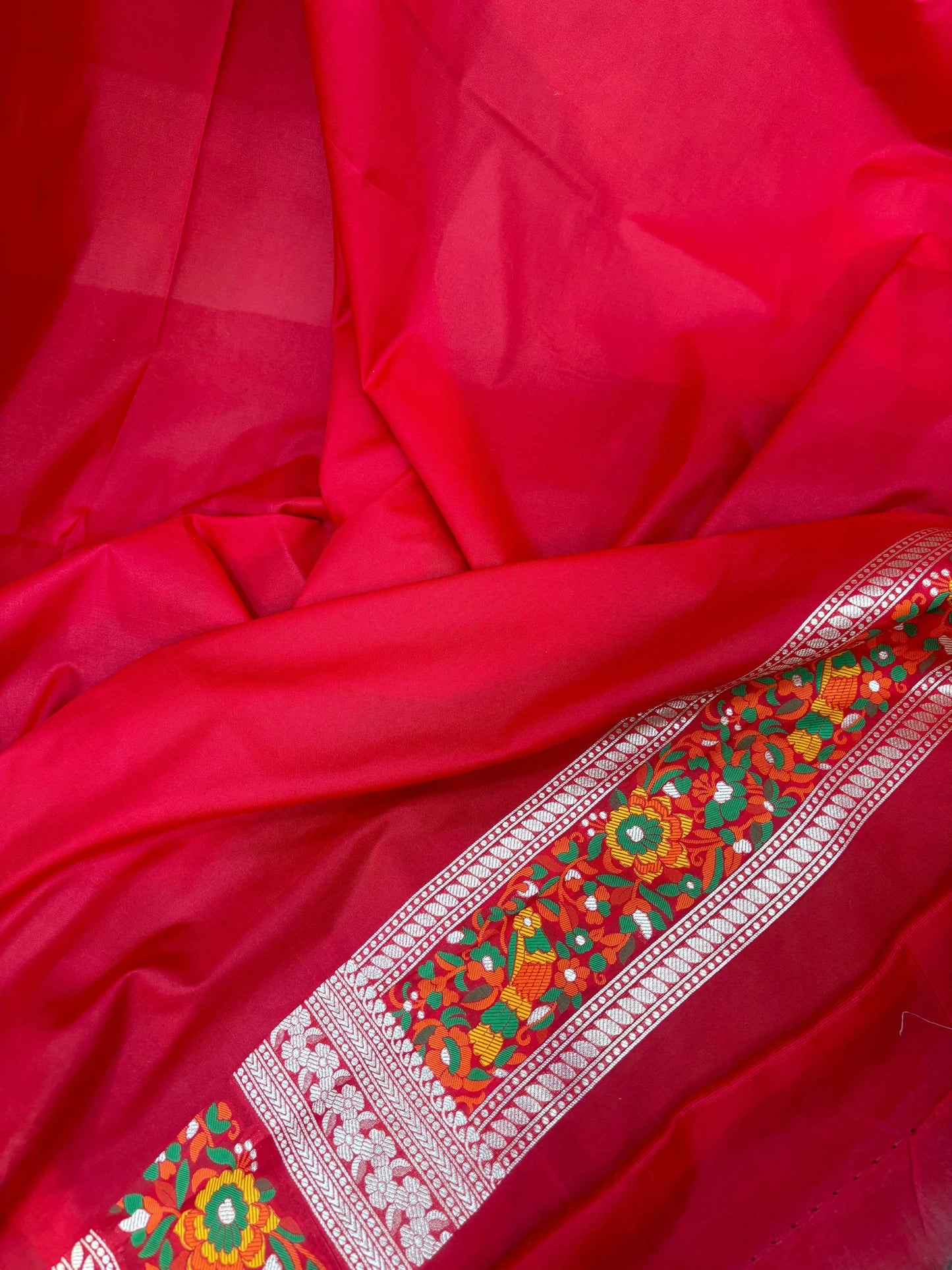 Maroon silk saree with green and white floral stripe border