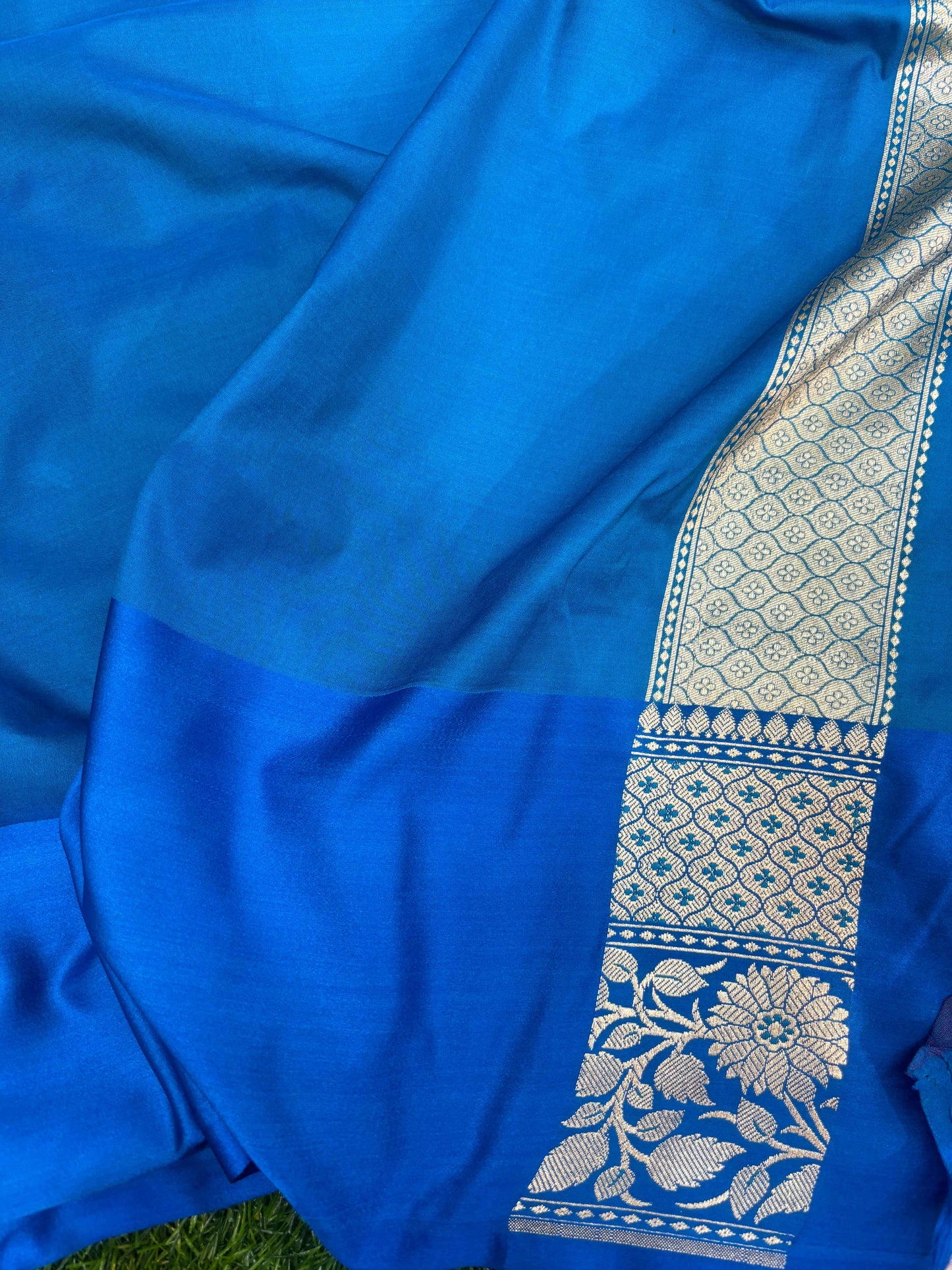 Royal blue silk saree with gold woven border and floral panel detail