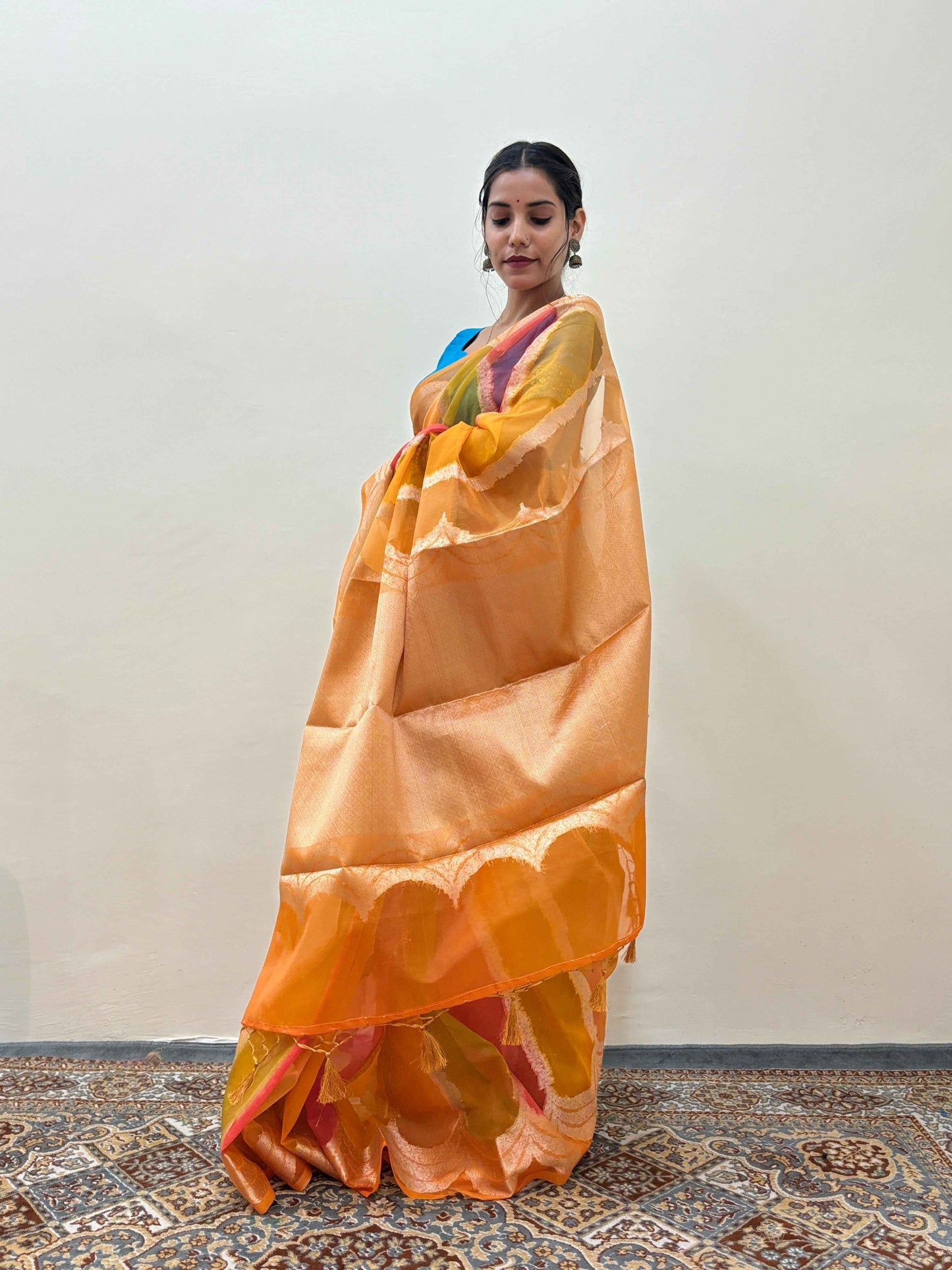 Orange and yellow handloom saree with contrasting woven border, full drape.