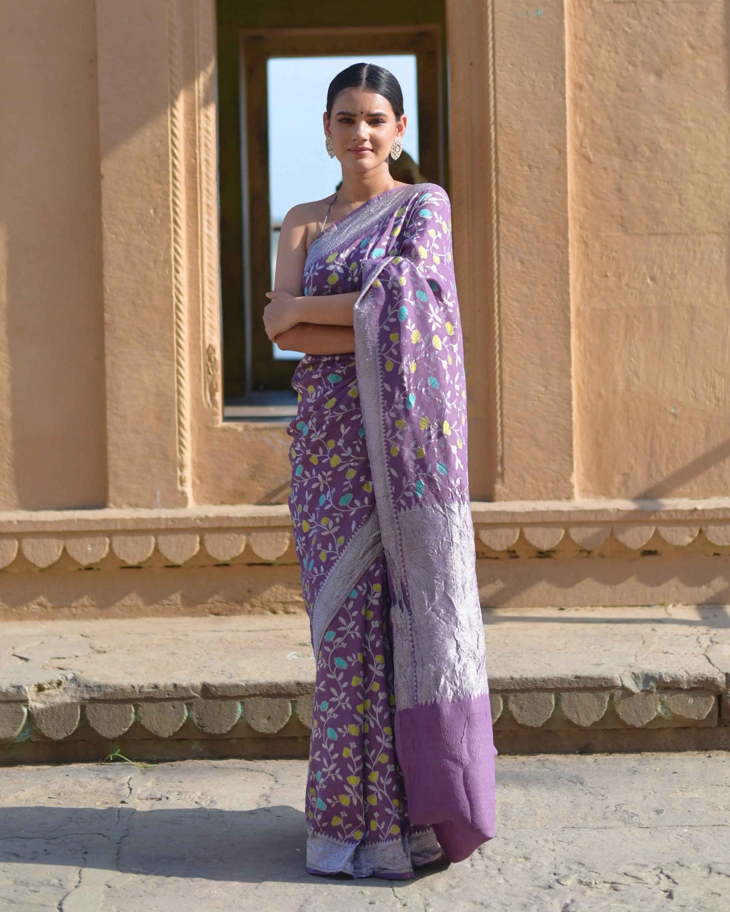 Lavender saree with purple floral print and light woven border, draped on model