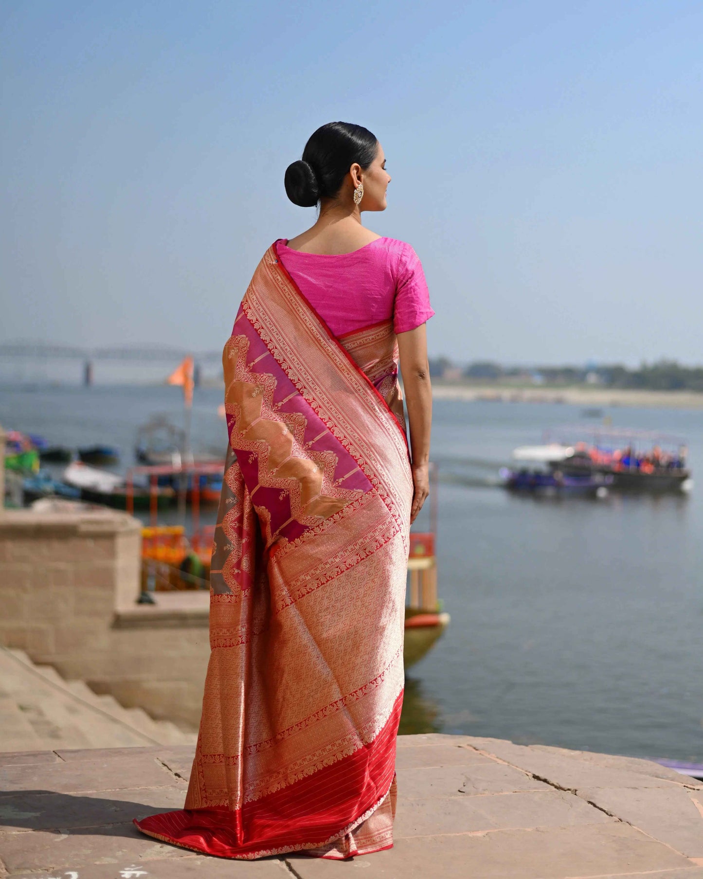 Pink and magenta saree with patterned pallu, visible back drape and woven border.