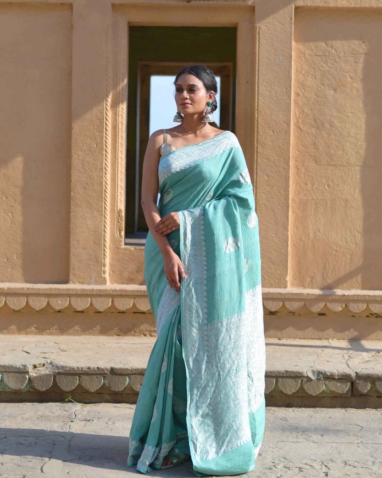 Light blue georgette saree with subtle zari border and draped pallu
