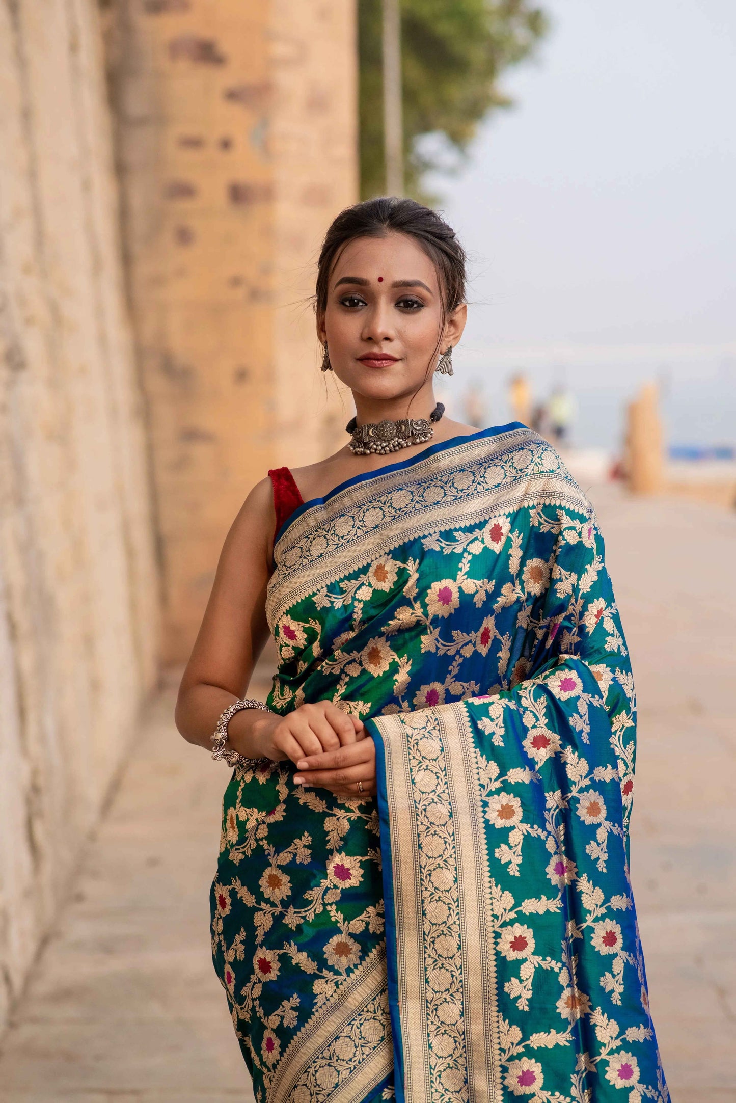Floral blue Banarasi-style saree with woven gold border and cutwork detail