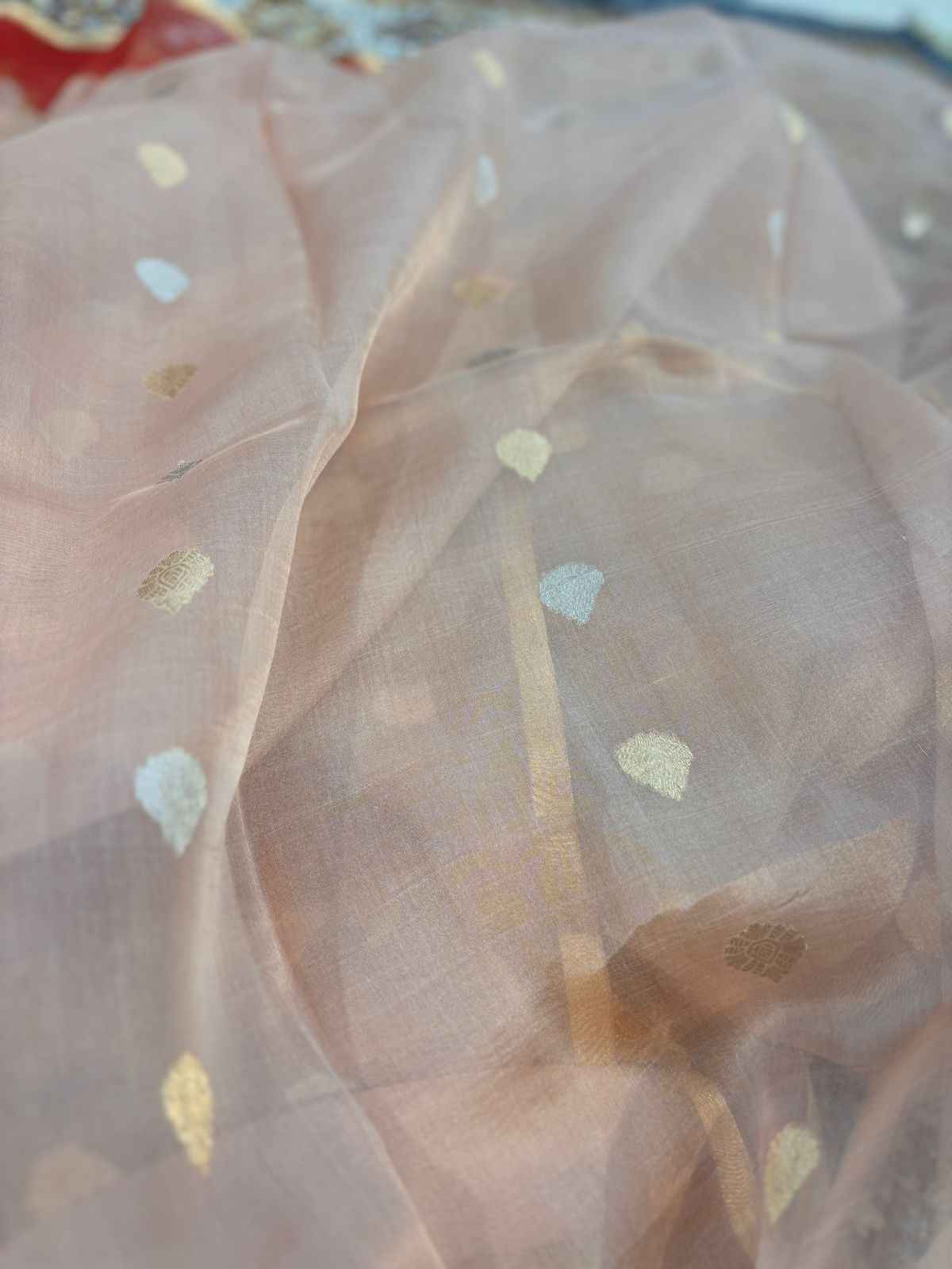 Peach sheer Banaras handloom saree with small gold motifs and drape