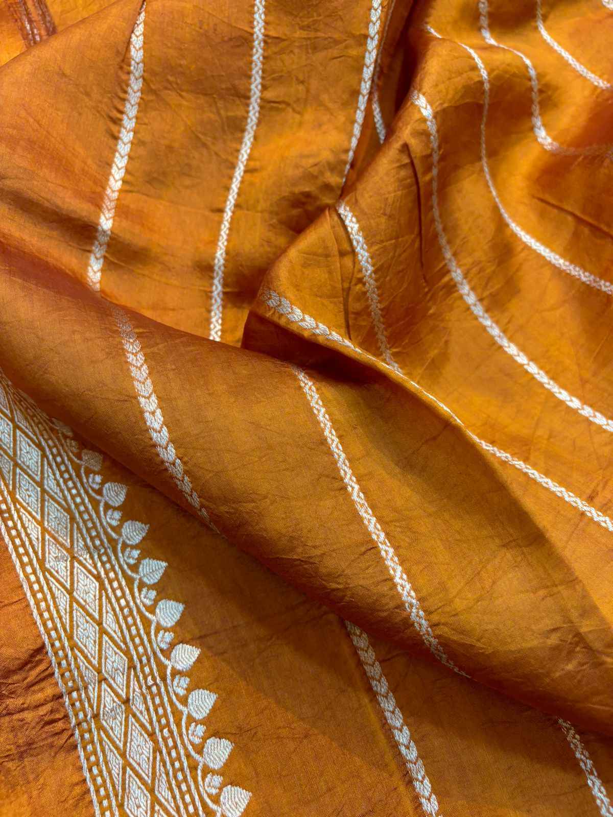 Mustard yellow saree with white dashed stripes and woven geometric border