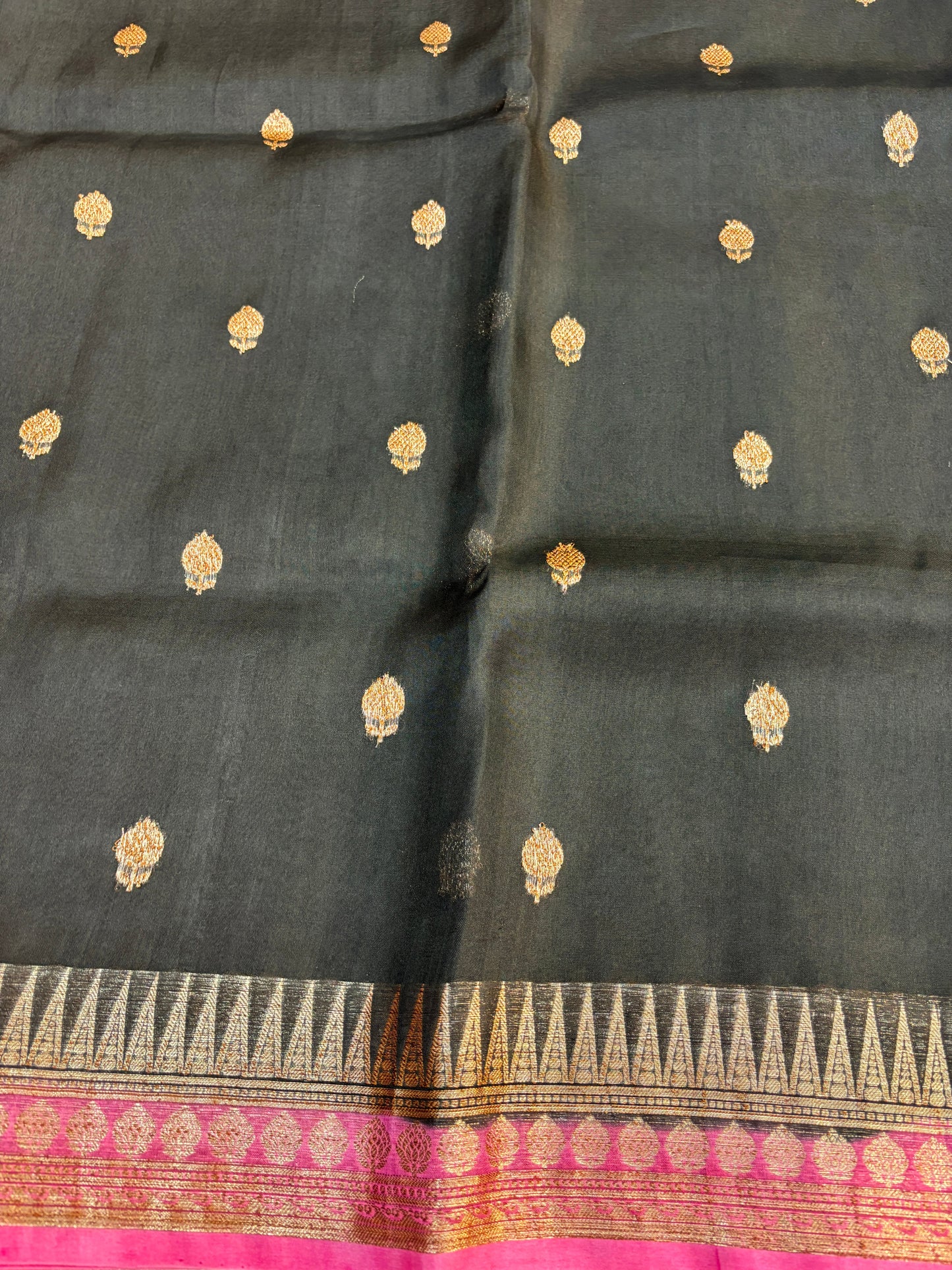Dark charcoal silk saree with gold motifs and patterned border