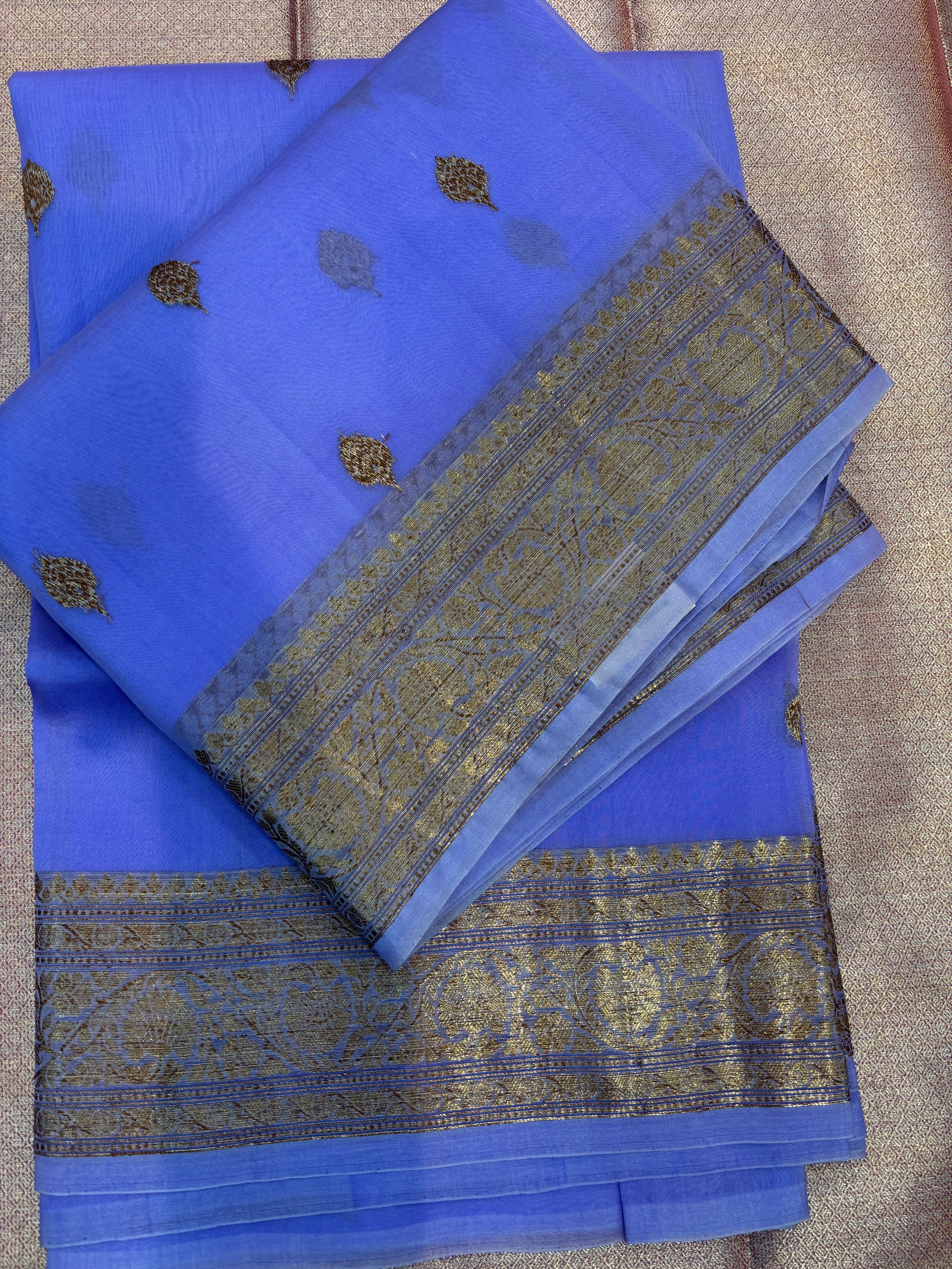 Lavender silk saree folded with gold motif repeat and gold striped border