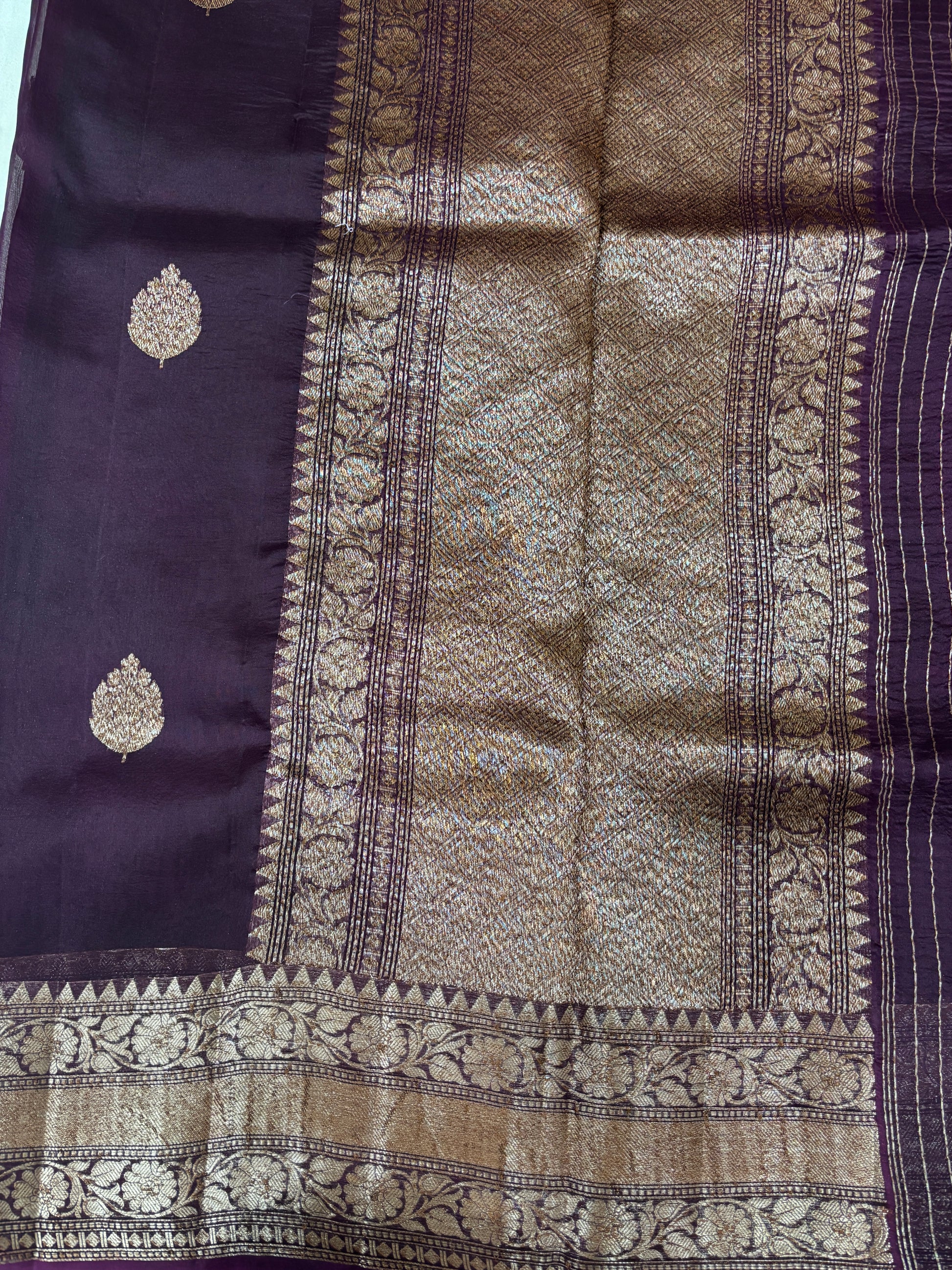 Purple silk saree with gold pallu panel, vertical zari stripes, and patterned border