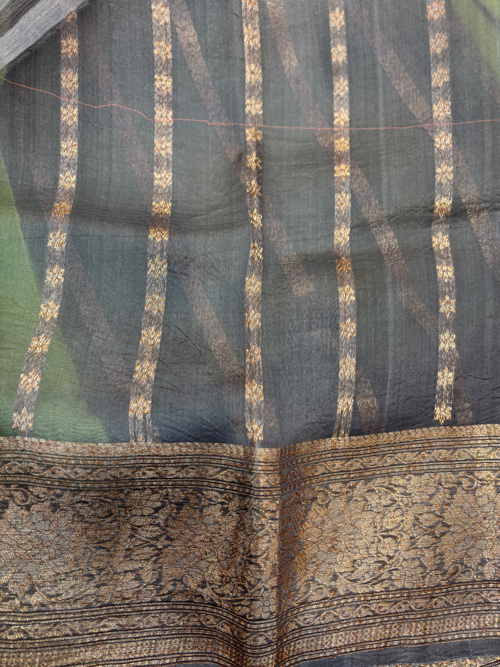 Charcoal silk saree with gold woven stripes and ornate zari-style border