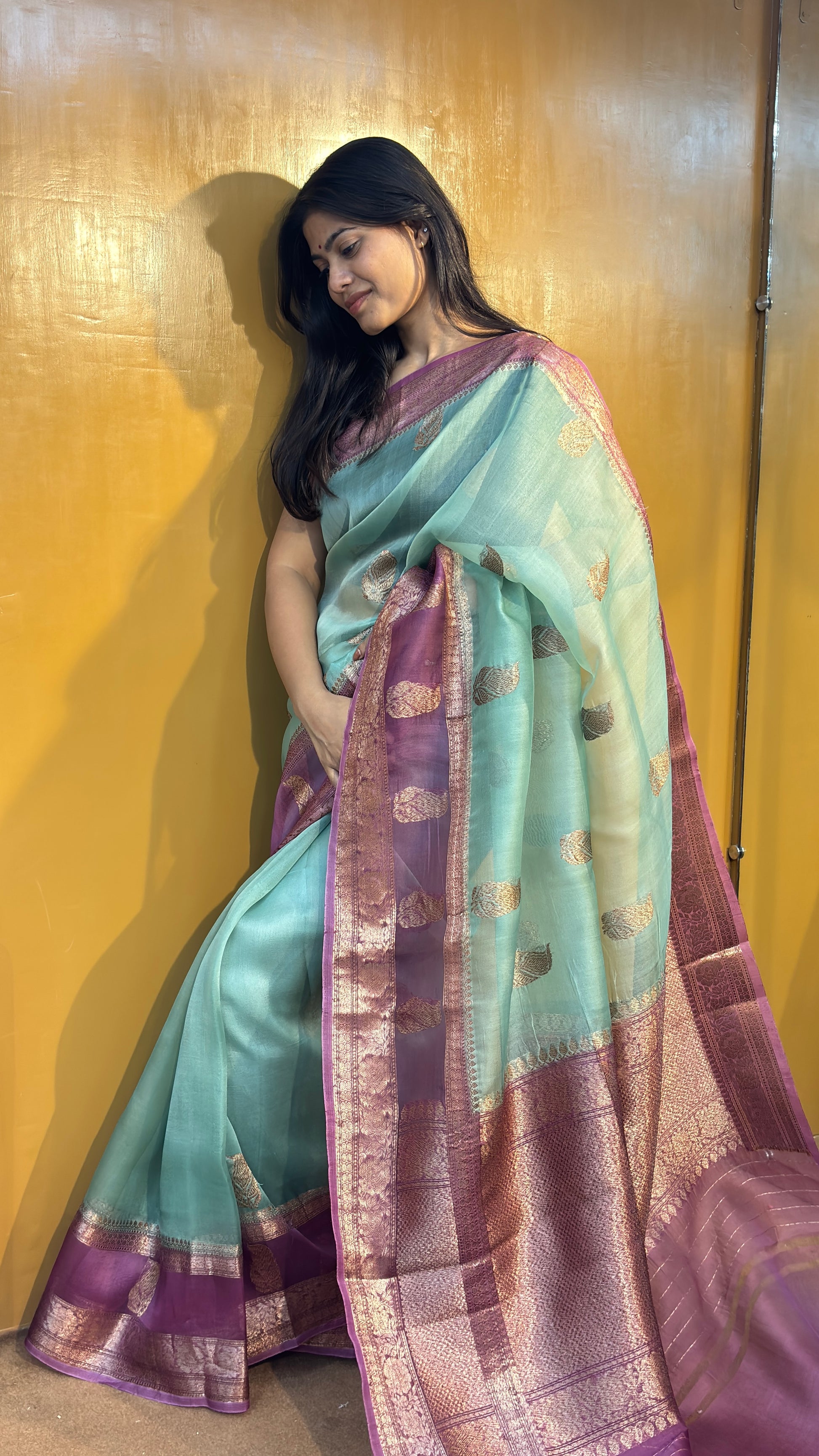 Banarasi handloom saree in turquoise with gold motifs and purple-maroon border