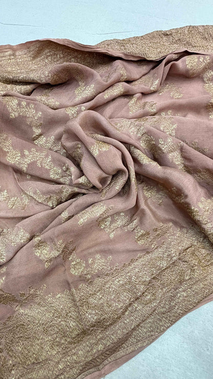 Dusty pink saree fabric with gold zari motifs, softly crinkled texture