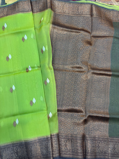 Green and charcoal silk saree with leaf-like gold motifs and woven border