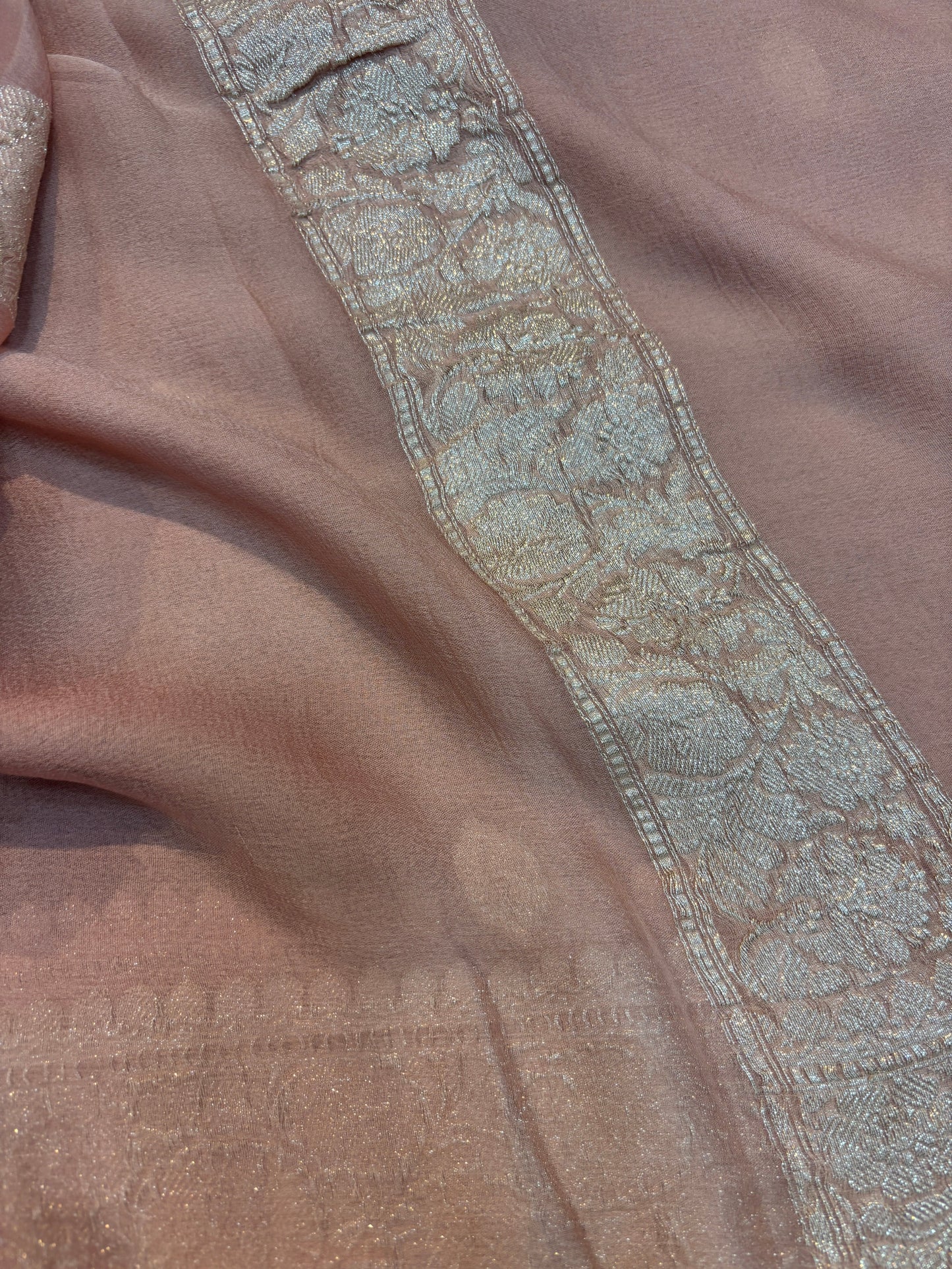Dusty pink Banarasi handloom saree with silver-tone embroidered border and ornate band.
