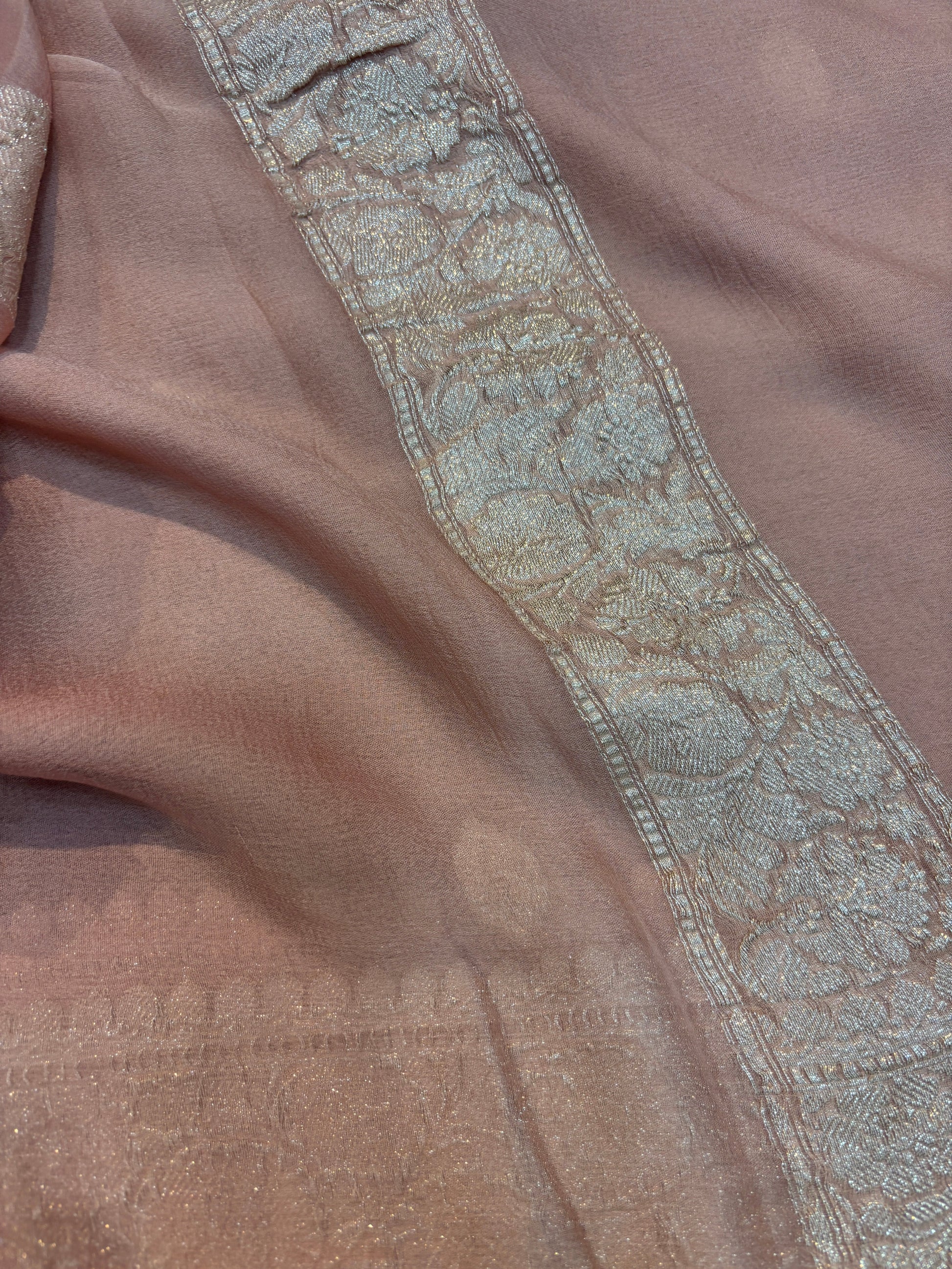Dusty pink Banarasi handloom saree with silver-tone embroidered border and ornate band.