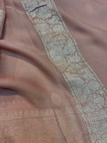 Dusty pink Banarasi handloom saree with silver-tone embroidered border and ornate band.