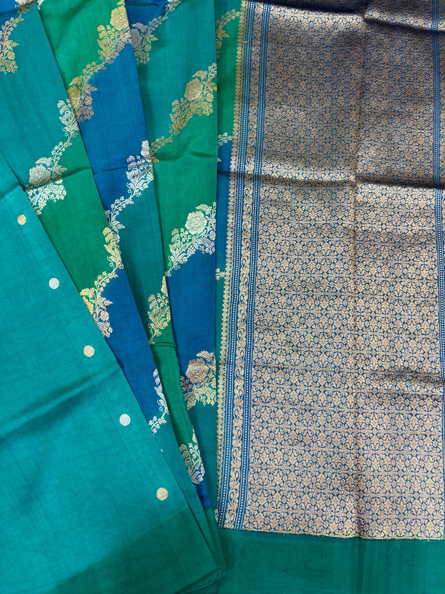 Teal and green Banarasi silk saree with ornate vine border and patterned pallu