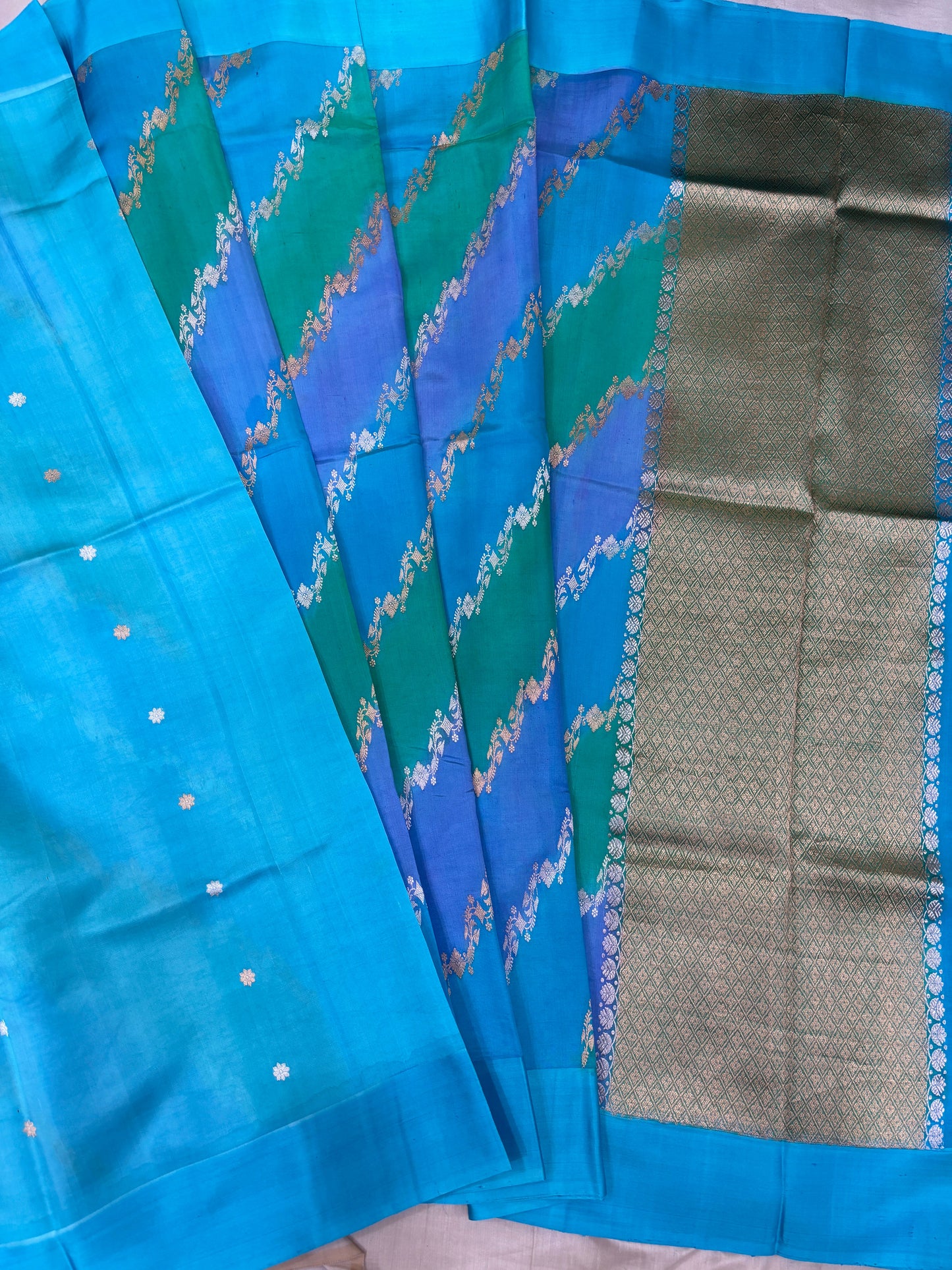 Blue silk saree with chevron floral pattern and wide gray-silver border