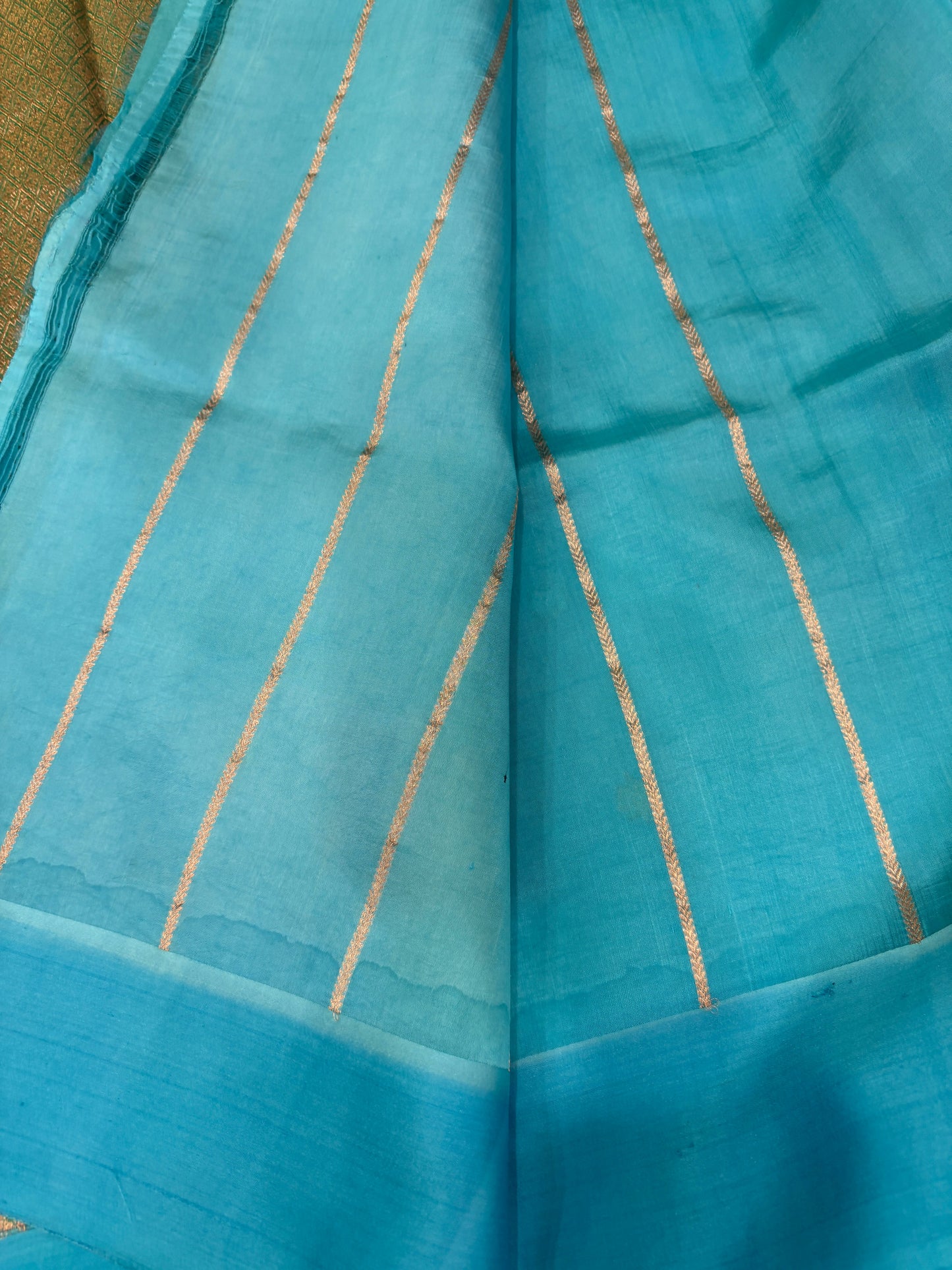 Silk saree in light blue with thin gold vertical stripes