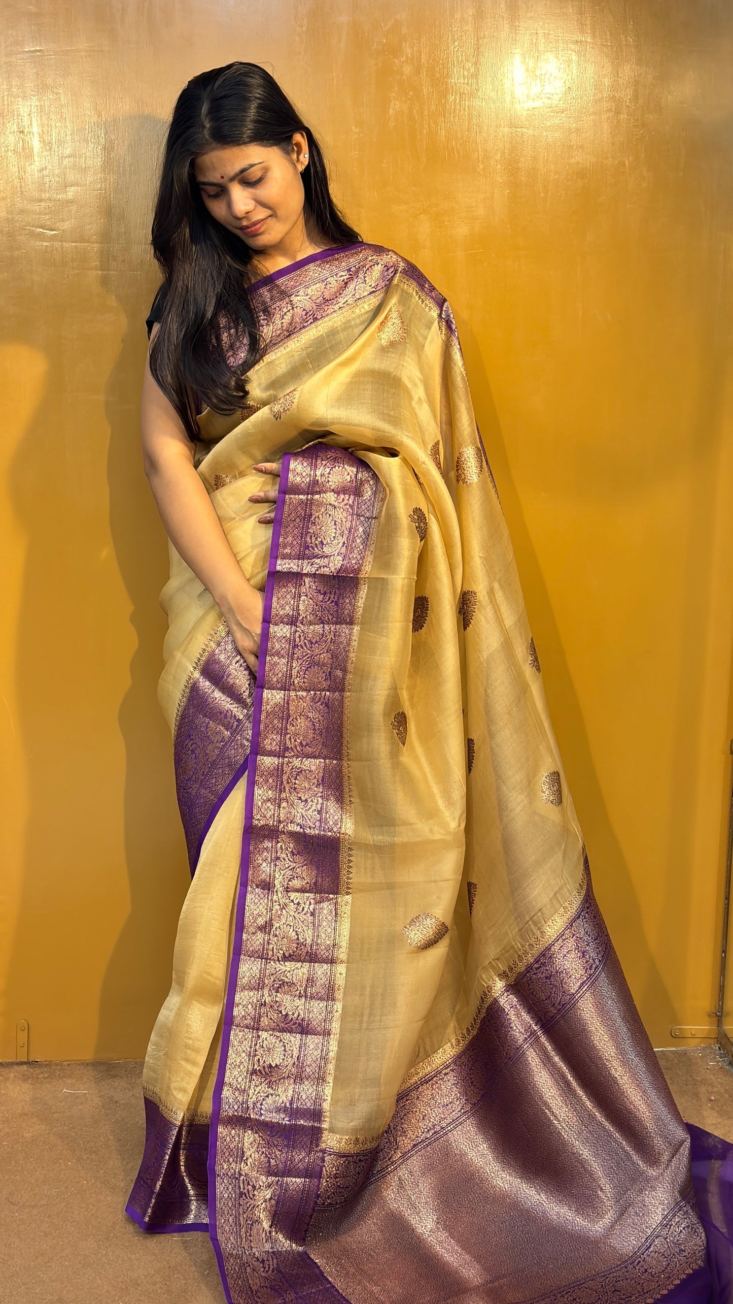 Gold-beige saree with purple woven border and small gold motifs