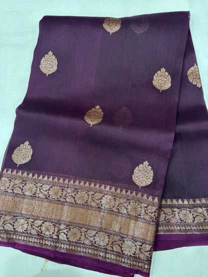 Purple silk saree with gold leaf motifs and wide zari border with floral patterns
