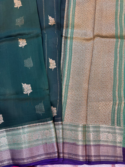 Teal handloom saree with small gold motifs, green woven border, and beige panel