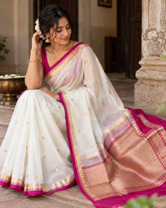 White silk saree with magenta-pink pallu and zari border