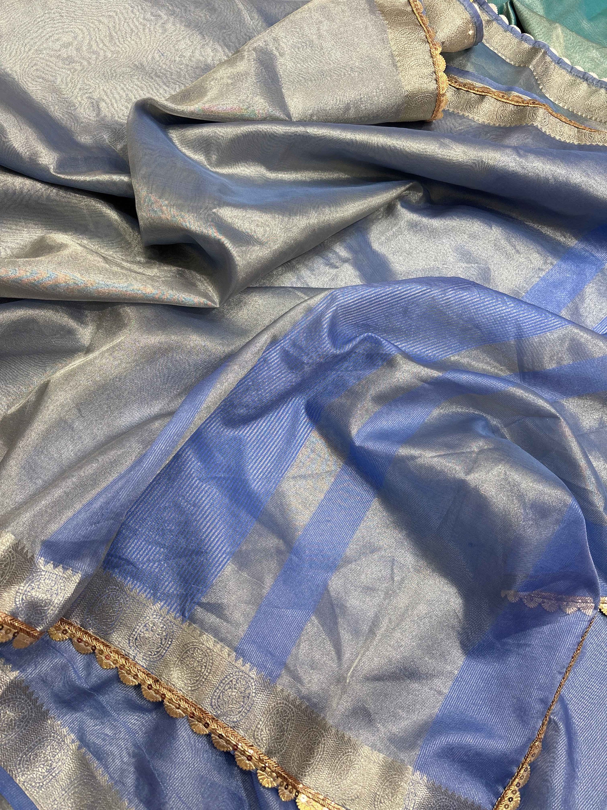Light blue tissue saree with gold-edged lace border