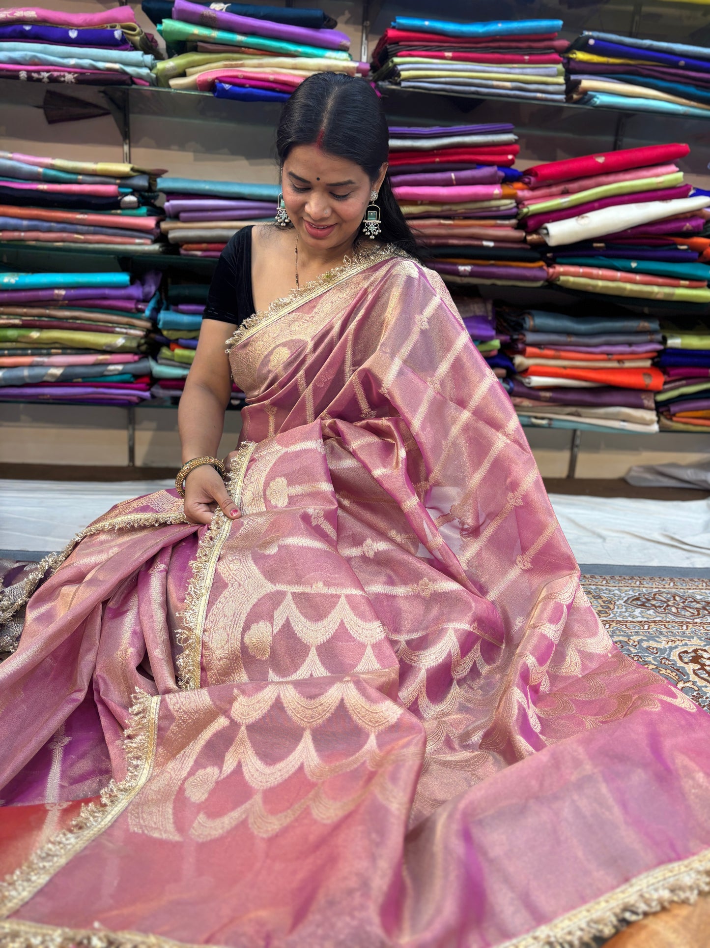 Pink tissue saree with gold-toned lace border and scalloped pattern pallu