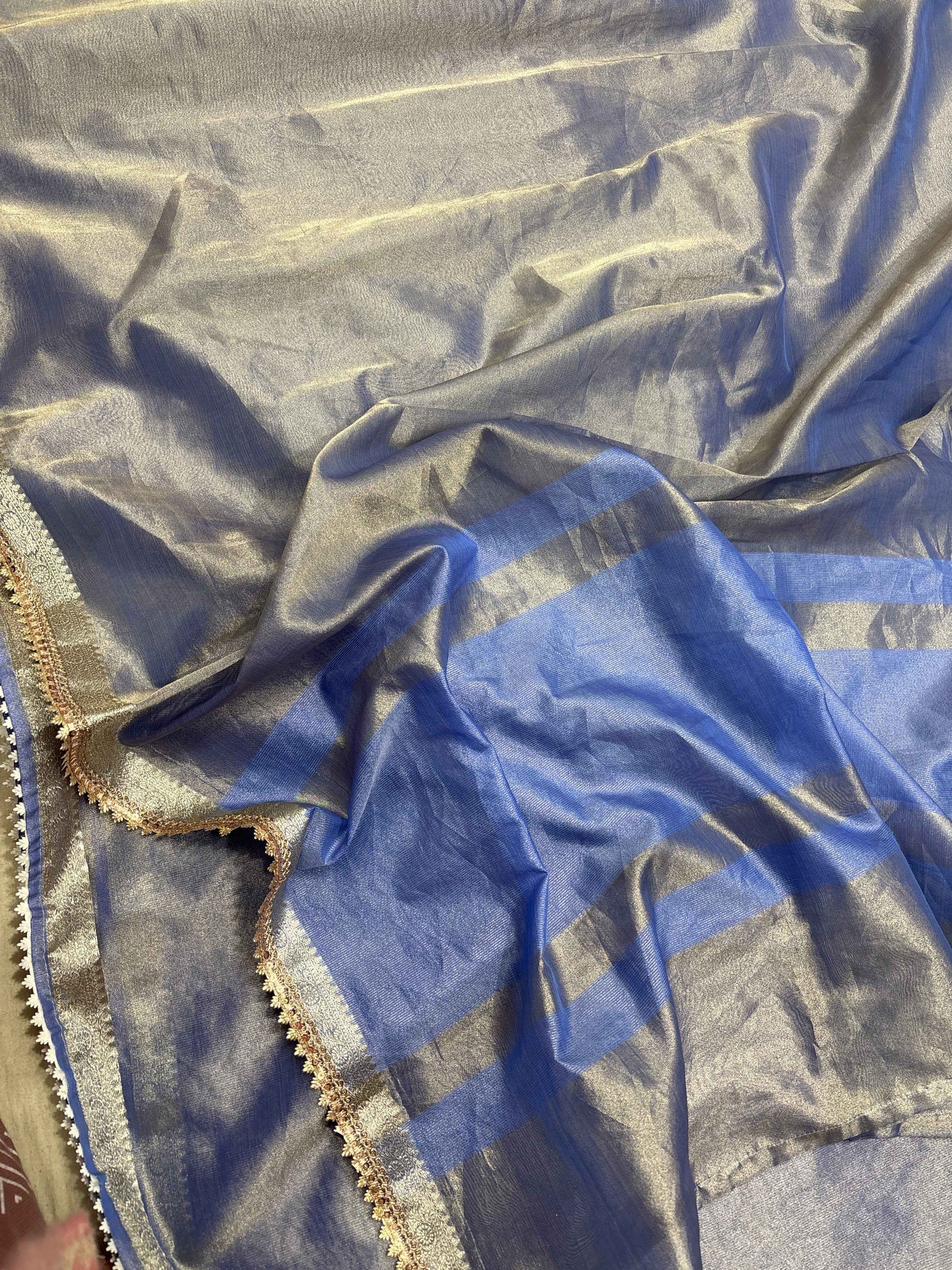 Powder blue tissue saree with gold and silver lace border