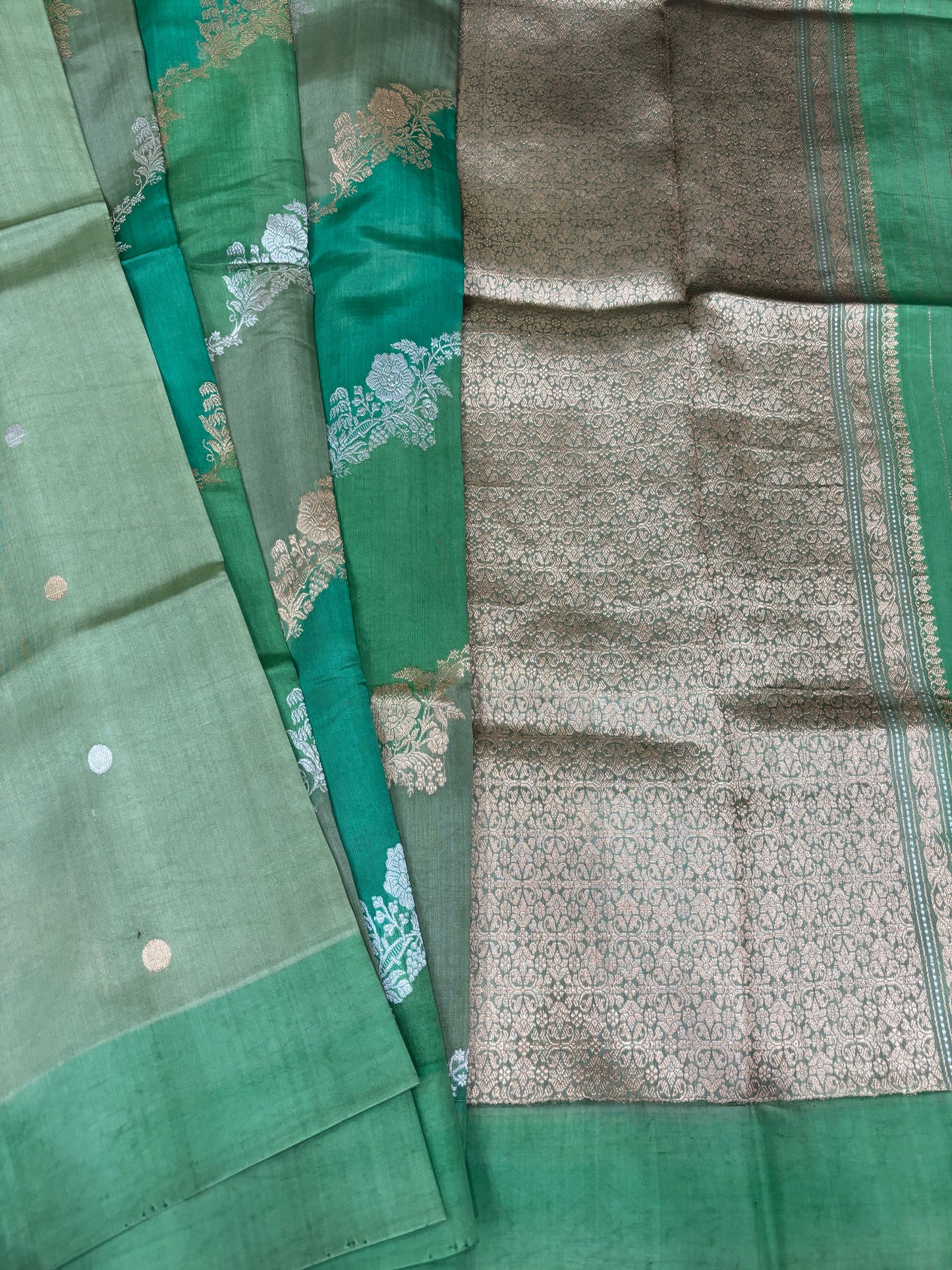 Green silk saree with teal and silver patterned sections plus contrast border