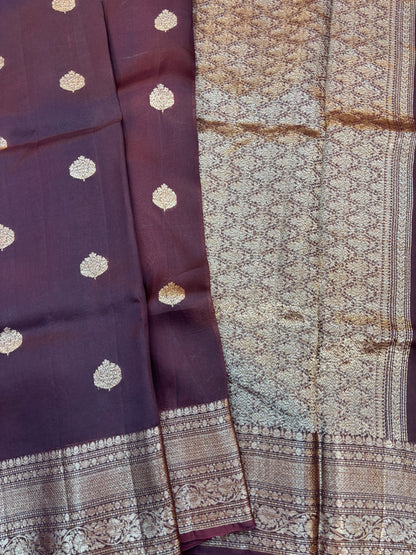 Plum silk saree with gold dot motifs, patterned pallu panel, and zari border