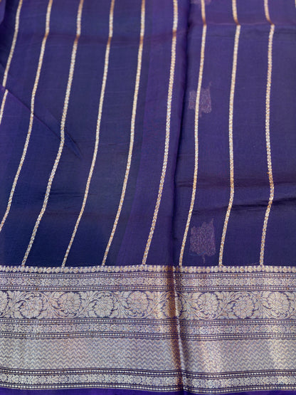 Dark blue handloom saree with gold stripe pattern and ornate silver border