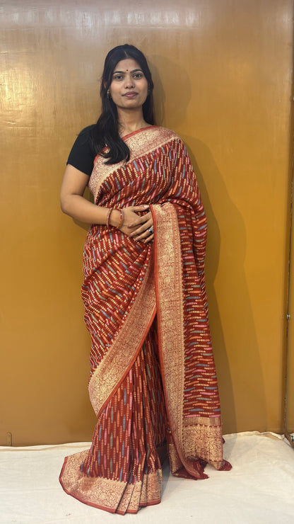 Pink saree with gold-toned pattern, cream-gold border at hem, side drape