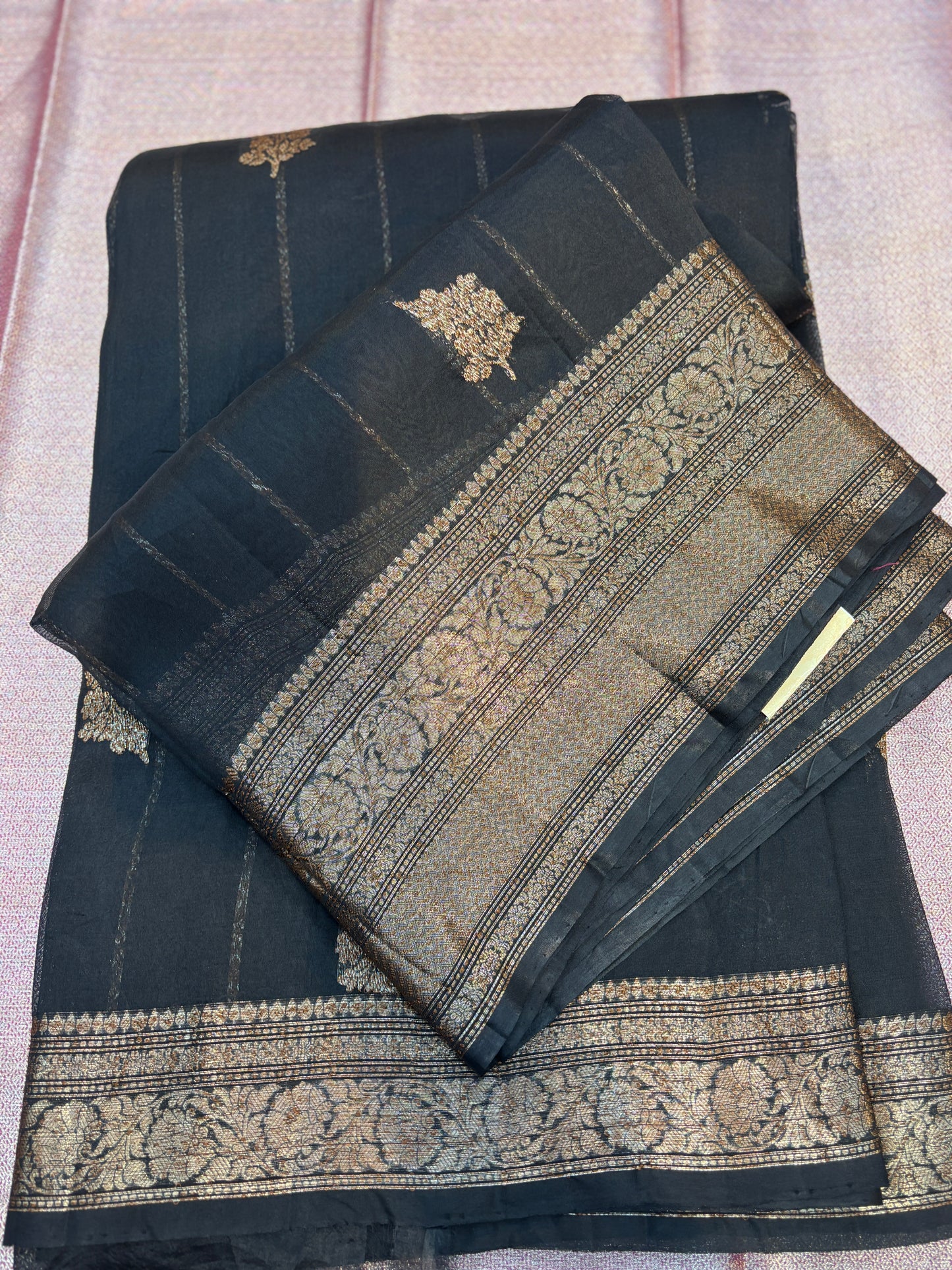Dark silk saree with gold zari woven borders and folded pallu