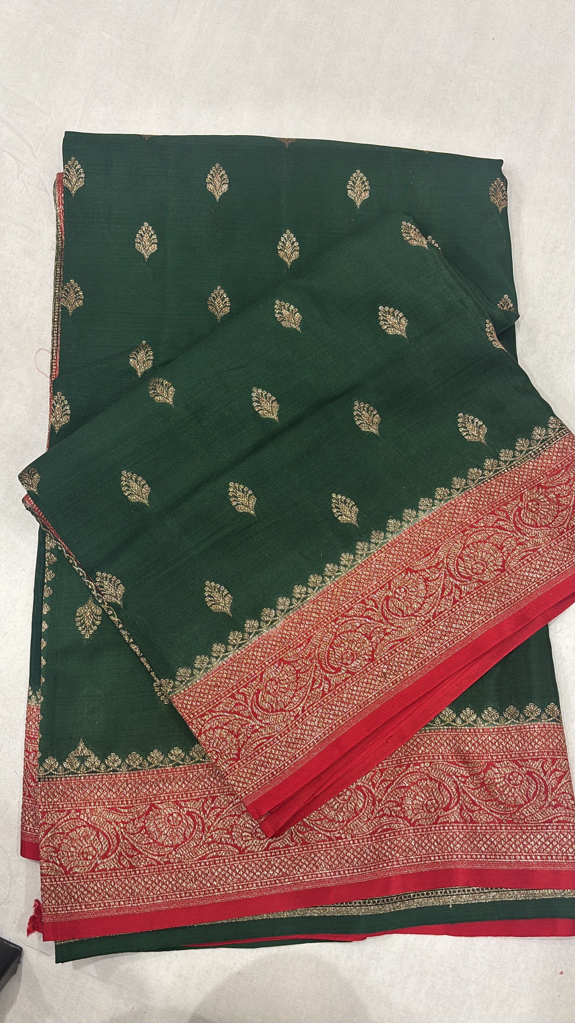 Green saree with red woven border and gold leaf motif pattern