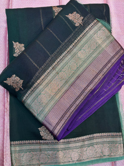 Folded teal and purple handloom saree with gold motifs and striped zari border