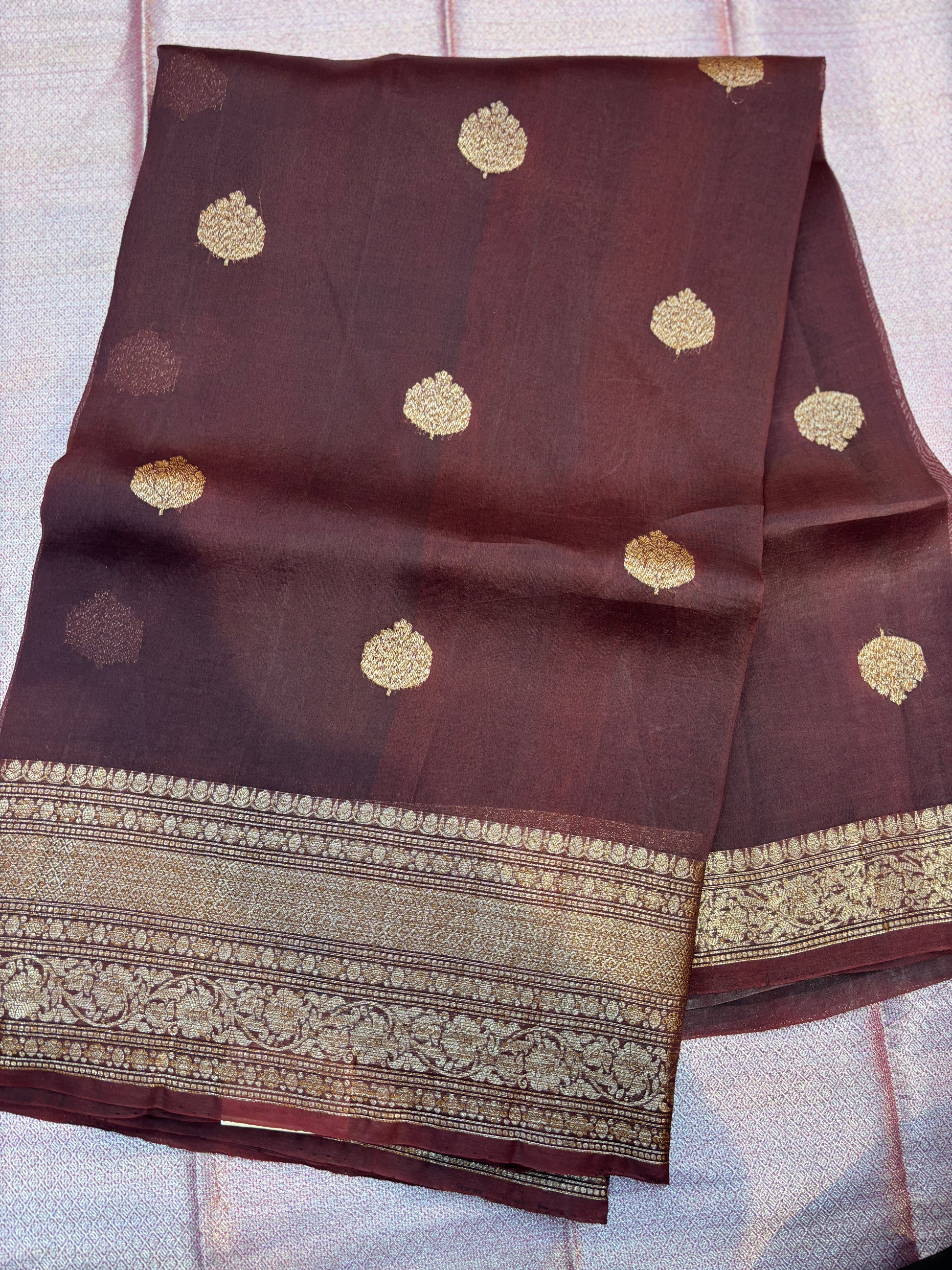 Plum silk saree with repeating gold motifs and detailed zari border
