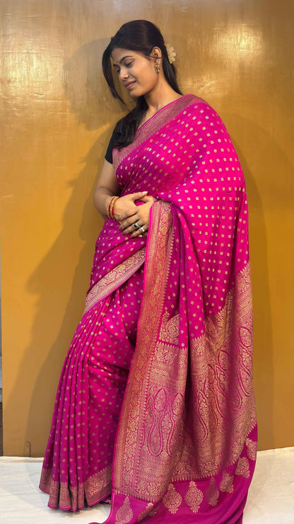 Pink saree with gold-toned border and scattered small motif pattern, draped