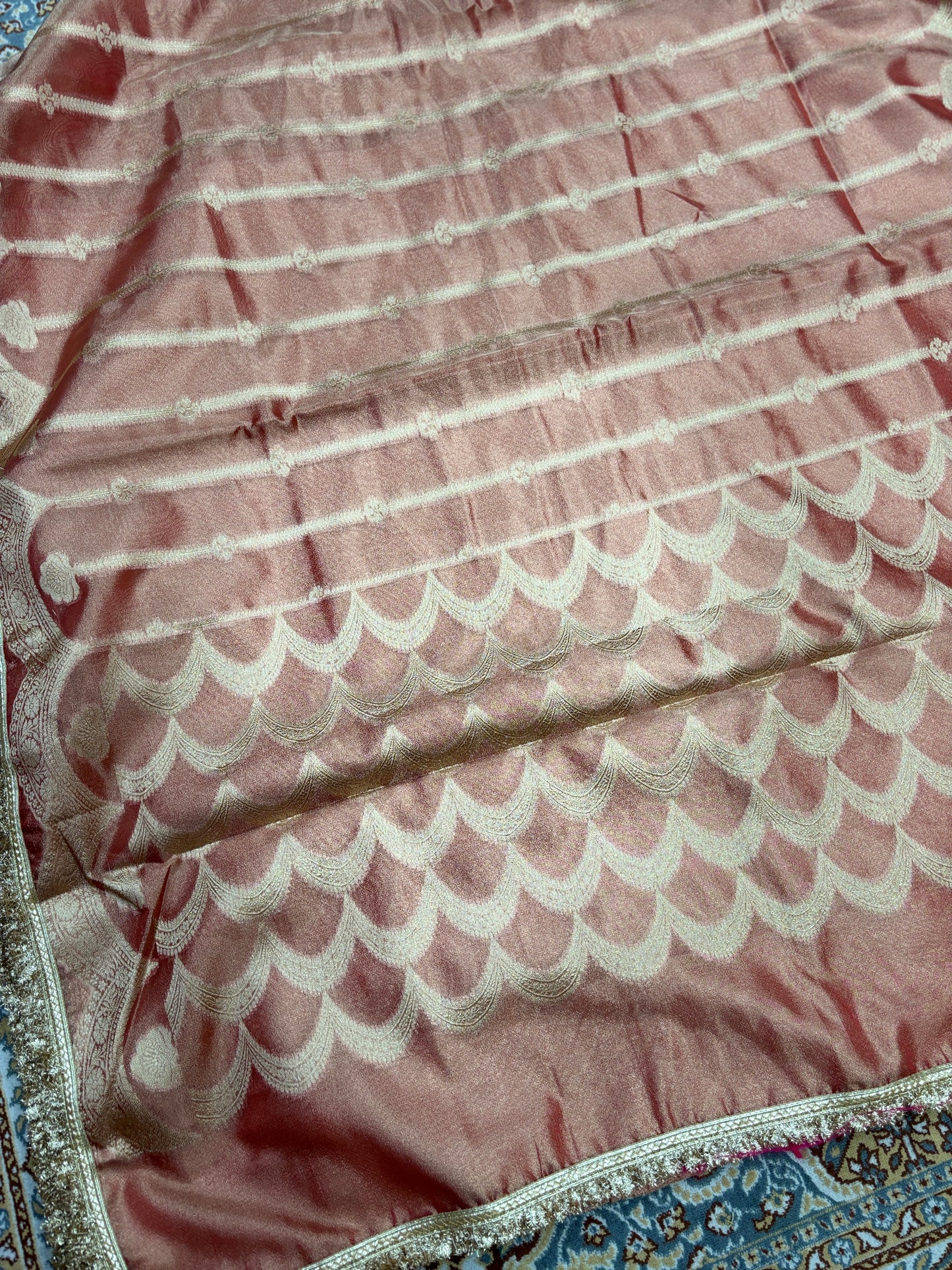 Rose-pink tissue saree with white scalloped motifs and metallic lace border